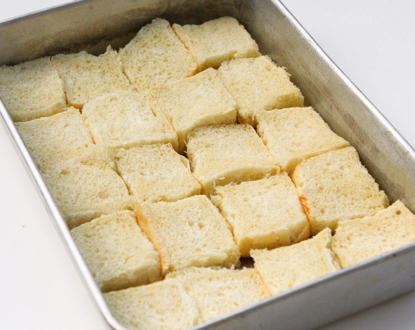 step 2 Coat a 9x13 baking dish with cooking spray. Line the bottom of a pan with the bottom halves of the Hawaiian Rolls (24).