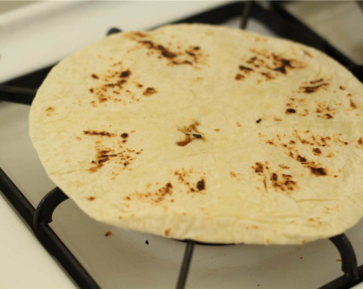 step 10 Toast the Tortillas (4) in a toaster oven or directly on the fire (10 seconds on the fire should do) - be careful not to let it burn!