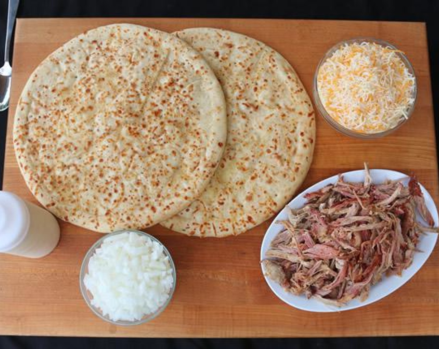 step 3 Divide White Sauce and spread over each Prepared Pizza Crusts (2). Mix Monterey Jack Cheese (4 Tbsp), Cheddar Cheese (4 Tbsp), and Mozzarella Cheese (4 Tbsp) in a bowl.