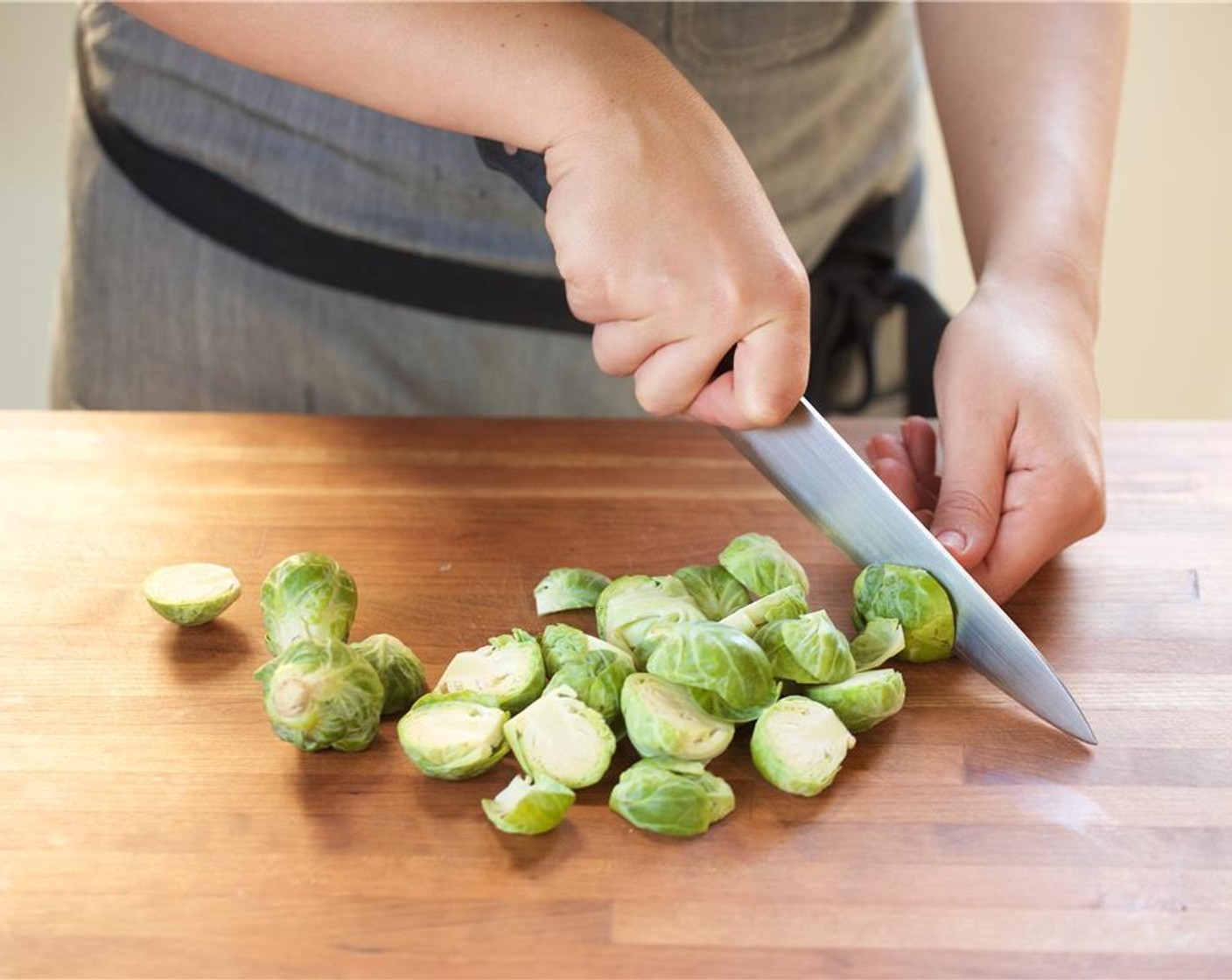 step 1 Heat a medium saucepan over high heat with eight cups of water. Finely chop the Shallot (1) and set aside. Cut the Scallion (1 bunch) into quarter inch thin slices. Set aside. Cut the Brussels Sprouts (2 1/2 cups) in half, and set aside.