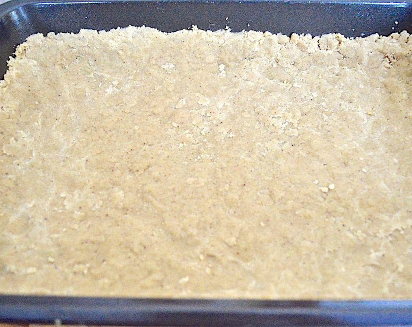step 5 Take 2/3 of the dough and press it firmly into the prepared baking dish to form a bottom crust, with it coming up the sides a bit to help hold the filling. Let the bottom crust chill for 20 minutes