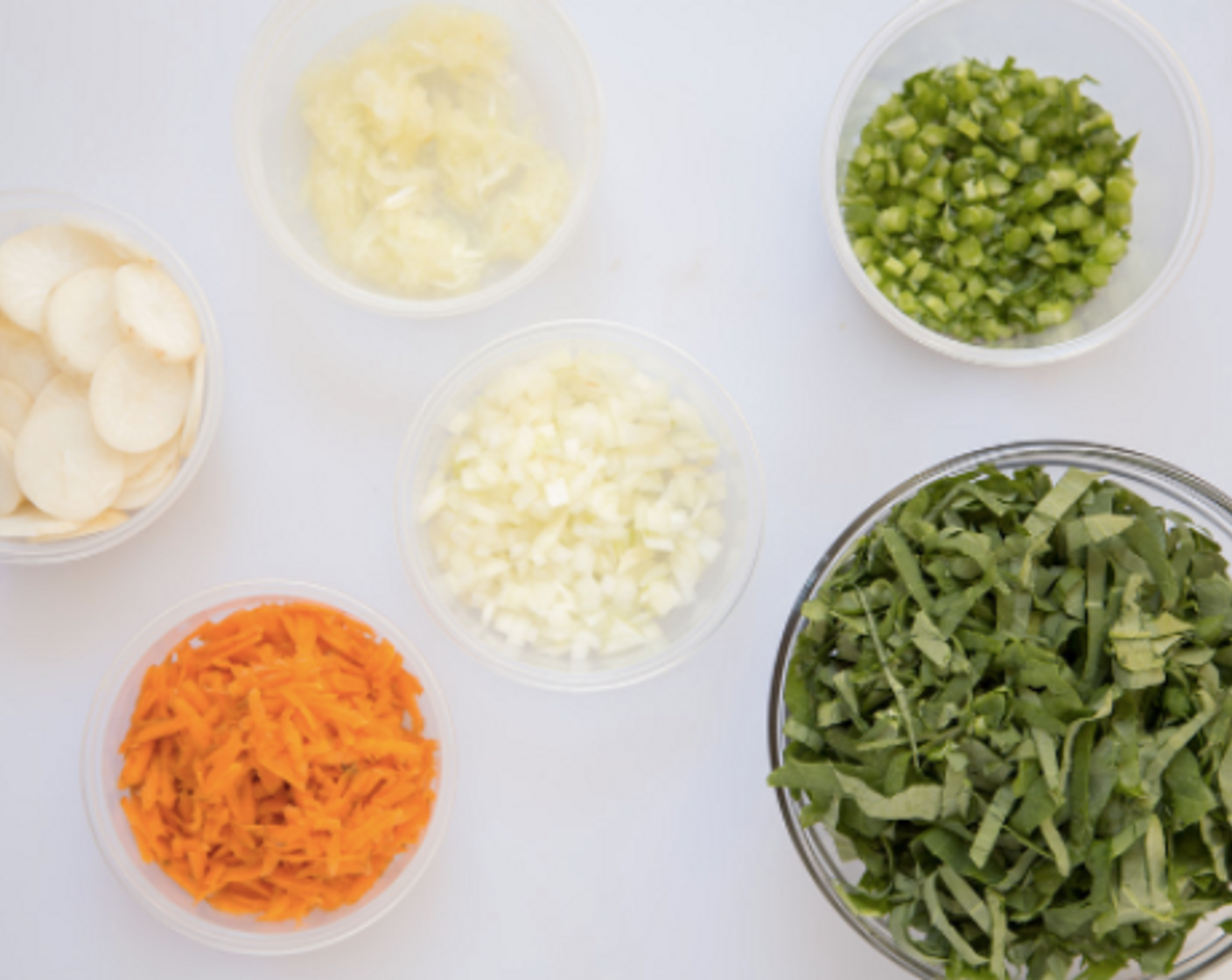 step 2 Trim Turnip (3/4 cup), and thinly slice. Grate Carrot (3/4 cup). Peel and halve the Yellow Onions (4 Tbsp); grate one half and measure out 1/4 cup; dice the other Yellow Onion (1/2).