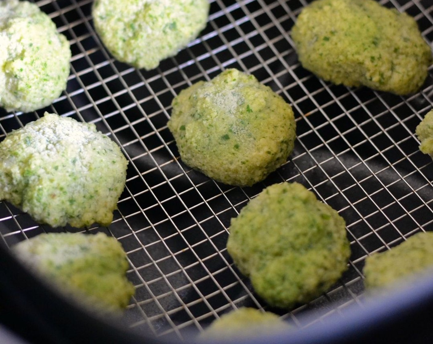 step 4 Spray or brush the basket with Oil (as needed). Put frozen falafel balls in a single layer at the bottom of the basket and wait a couple of minutes until their tops start to get a bit shiny. Then bake them for 10 minutes at 330 degrees F (165 degrees C).