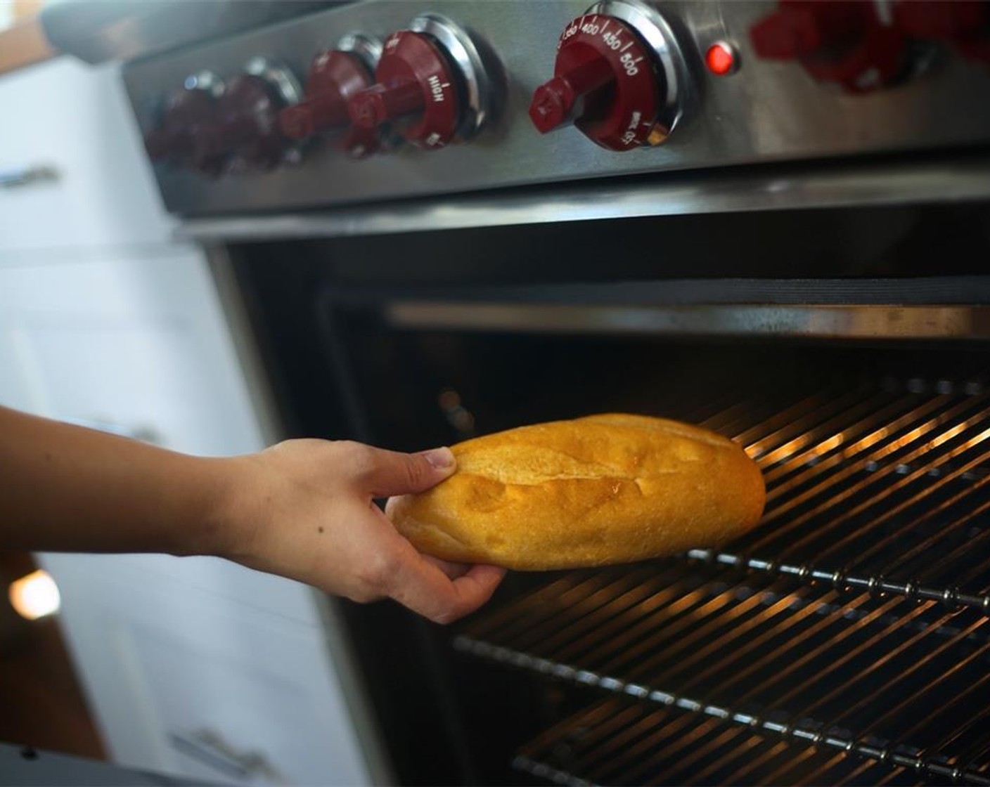 step 20 Using your hands, moisten outside of Baguettes (2) with a little bit of water. Place in oven directly on wire rack and bake for three minutes. Remove from oven and hold for plating.