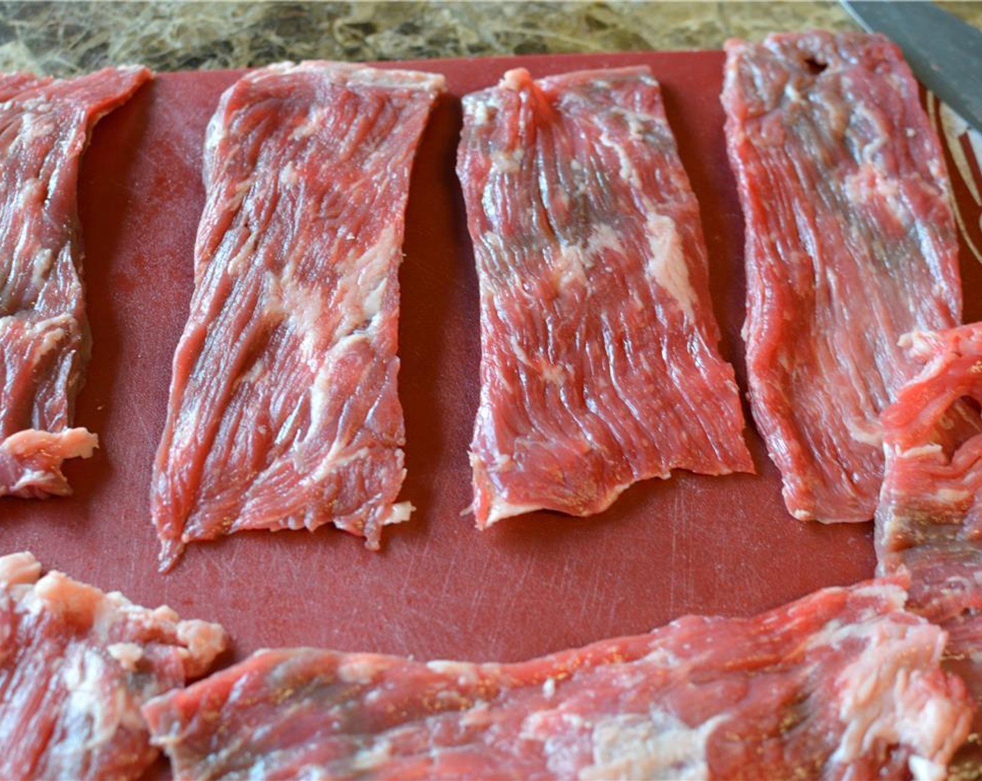 step 1 Start by prepping the Skirt Steak (1.5 lb). Trim as much fat as you can and cut the steak into 3-inch wide strips.