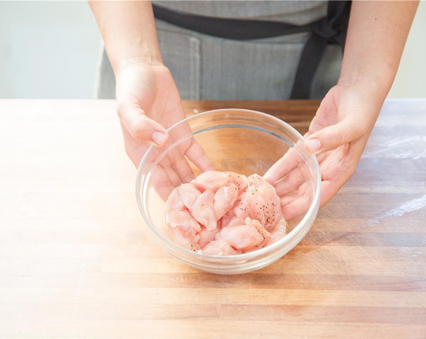 step 2 Meanwhile, pat dry Skinless Chicken Breasts (2) with paper towels and cut into one inch pieces. Place into a medium bowl and season with Salt (1/4 tsp) and Ground Black Pepper (1/4 tsp).