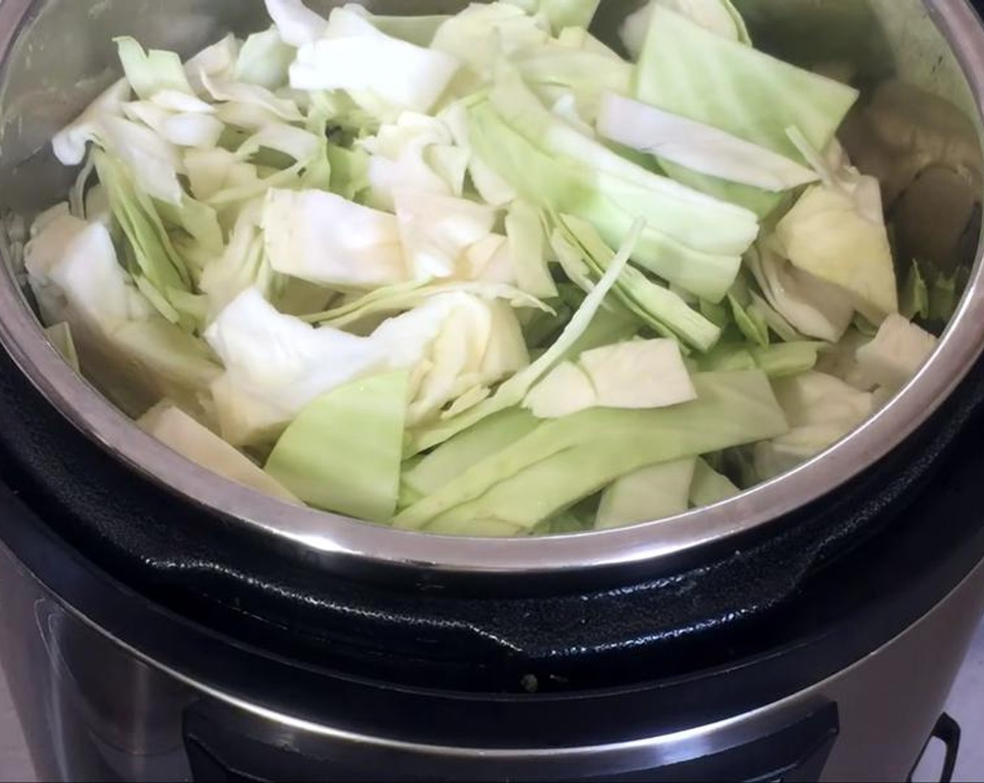 step 2 Add Vegetable Stock (3/4 cup) and a large Green Cabbage (1), after slicing it, and removing the core. Cook it for five minutes with the lid closed on the bean chili setting.