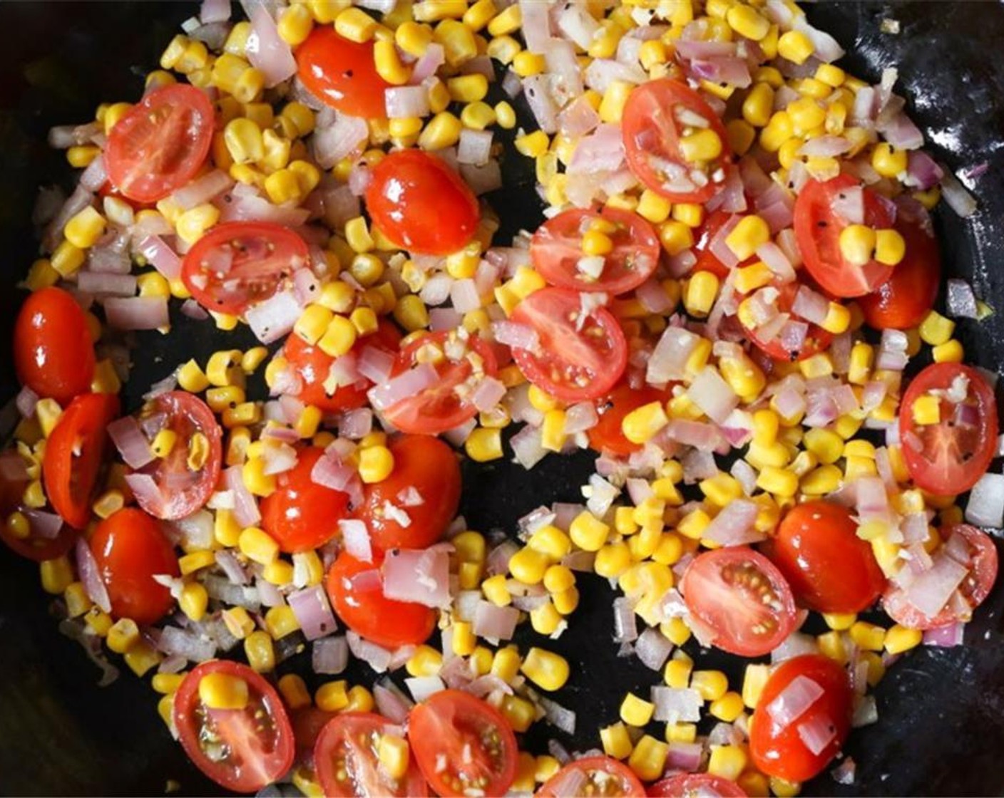 step 4 Season with Kosher Salt (to taste), Finely Ground Black Pepper (to taste). Cook until corn is tender and onions are translucent. Stir in Grape Tomatoes (1 cup)  and Garlic (3 cloves) and cook for 2 minutes until the tomatoes are just softened and the garlic is fragrant.