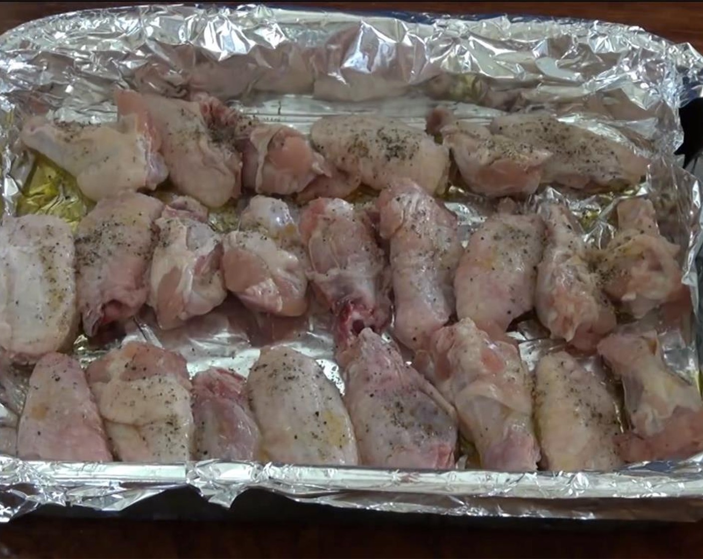 step 3 Drizzle the wings with Olive Oil (2 Tbsp), Salt (1/2 Tbsp), and Ground Black Pepper (1/2 Tbsp).