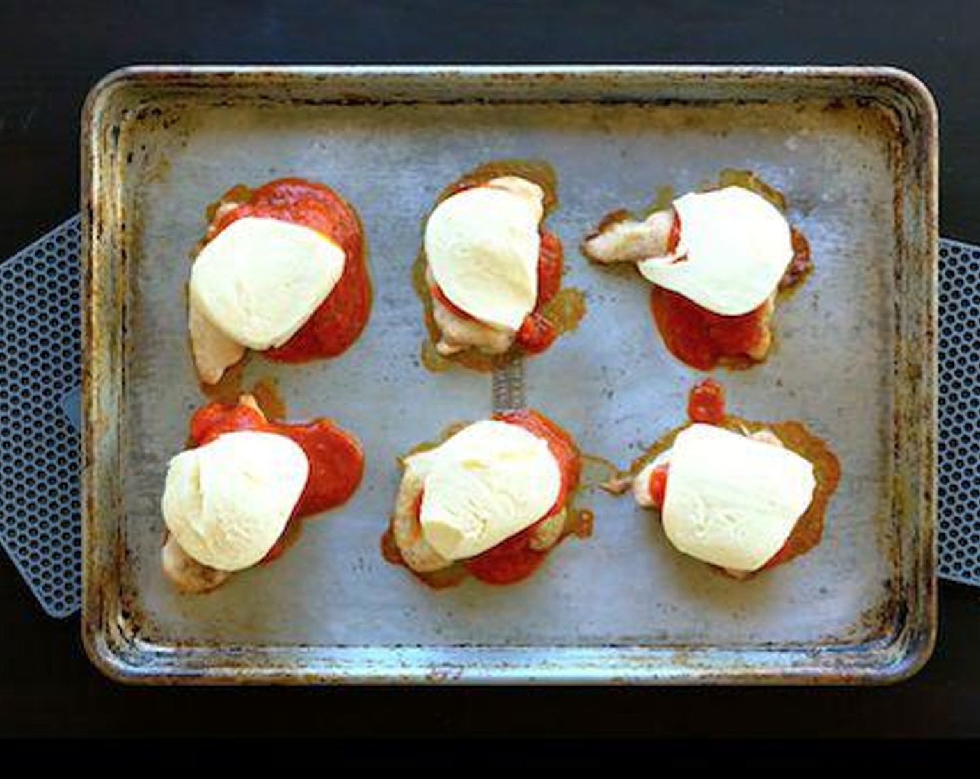 step 5 Pour half the Marinara Sauce (1 jar) over the chicken thighs. Top each with 1 slice of mozzarella and sprinkle with Grated Parmesan Cheese (2 Tbsp). Bake another 5 minutes until cheese is melted.