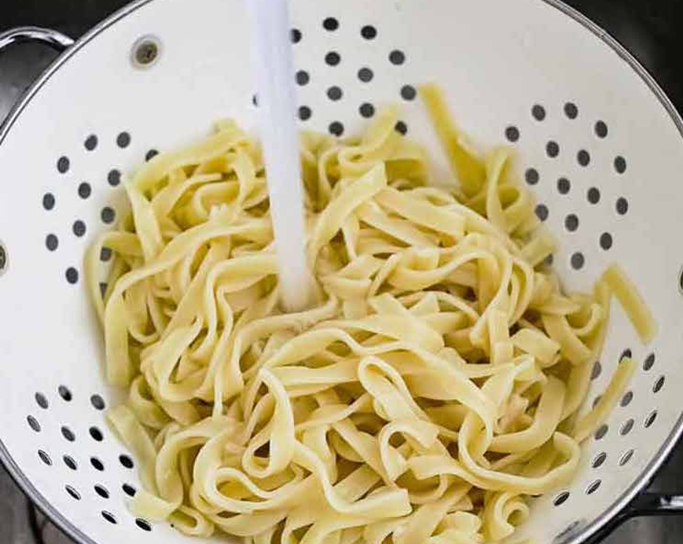 step 2 Rinse your tagliatelle with ice-cold water and shake through a sieve to remove as much water as possible. Set aside.