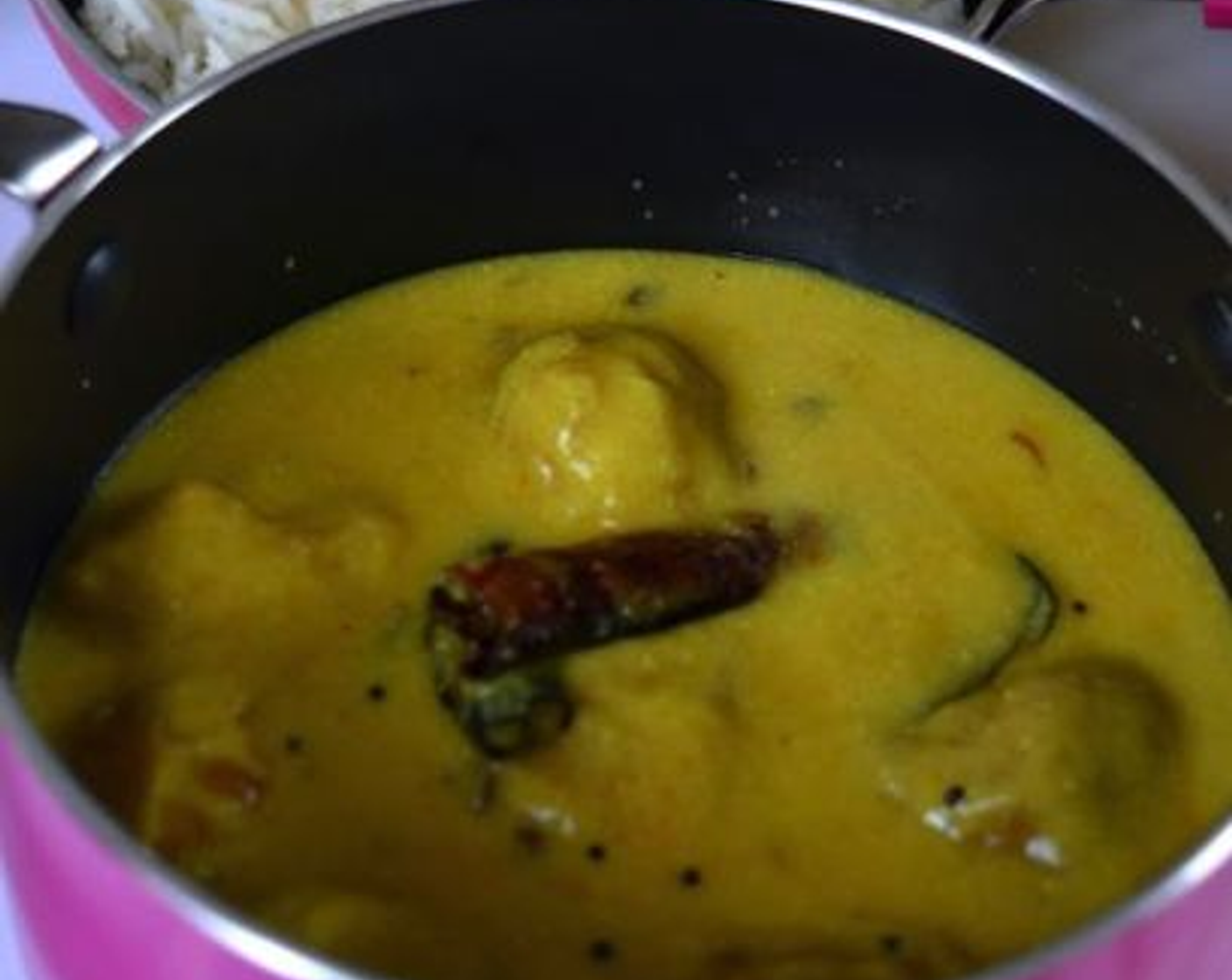 step 10 Add the fried pakoda's to the hot kadhi. Cover and close the pan. Let the onion pakoda's be soaked in the kadhi for a couple of minutes. Serve the punjabi kadhi pakora with warm rice, roti, paratha.