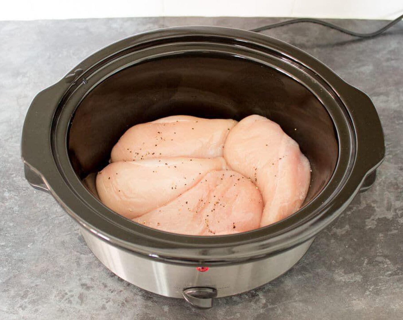 step 1 Place Boneless, Skinless Chicken Breasts (2 lb) into the slow cooker & season both sides of each one with Salt (to taste) and Ground Black Pepper (to taste).