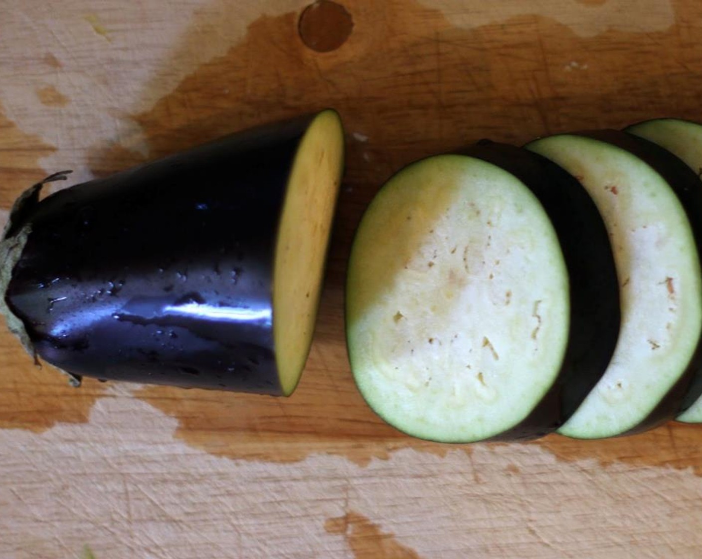 step 4 Slice four thick pieces of Eggplant (1/2) and coat lightly Sesame Oil (1/2 Tbsp), some Salt (to taste), and Ground Black Pepper (to taste). Place on a grill pan.