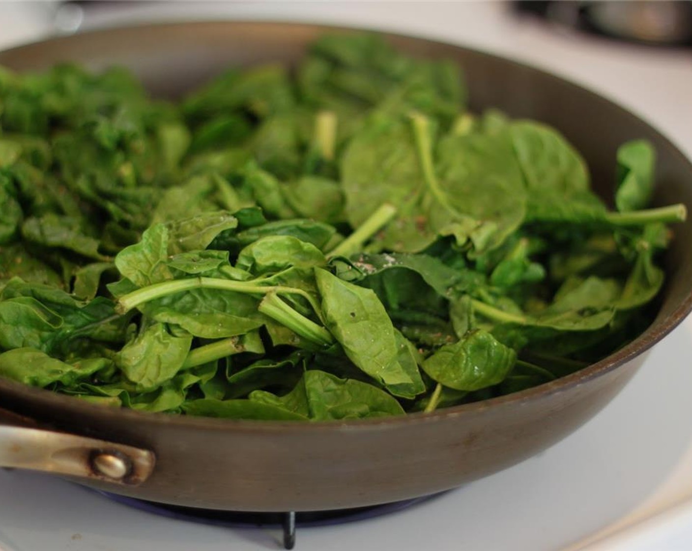 step 7 Heat the remaining Sesame Oil (1 Tbsp) in a pan and add the Spinach Leaves (1 pckg), Low-Sodium Soy Sauce (1 Tbsp), juice from Lemon (1), Rice Vinegar (1 1/2 Tbsp), Salt (to taste) and Ground Black Pepper (to taste).