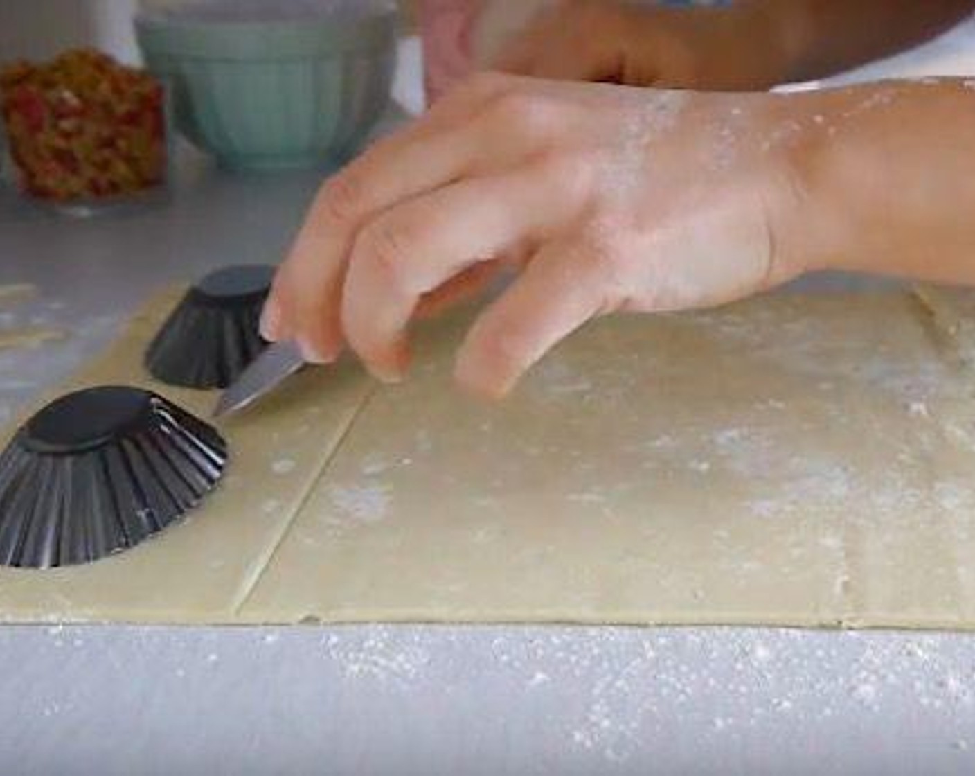 step 3 Add cooking spray to the molds to avoid sticking. Make each base by carefully pressing the dough against the mold, this will give you that perfect tart-like border. Then cut the excess dough using the back of the knife to avoid damaging the cutting edge of the knife.