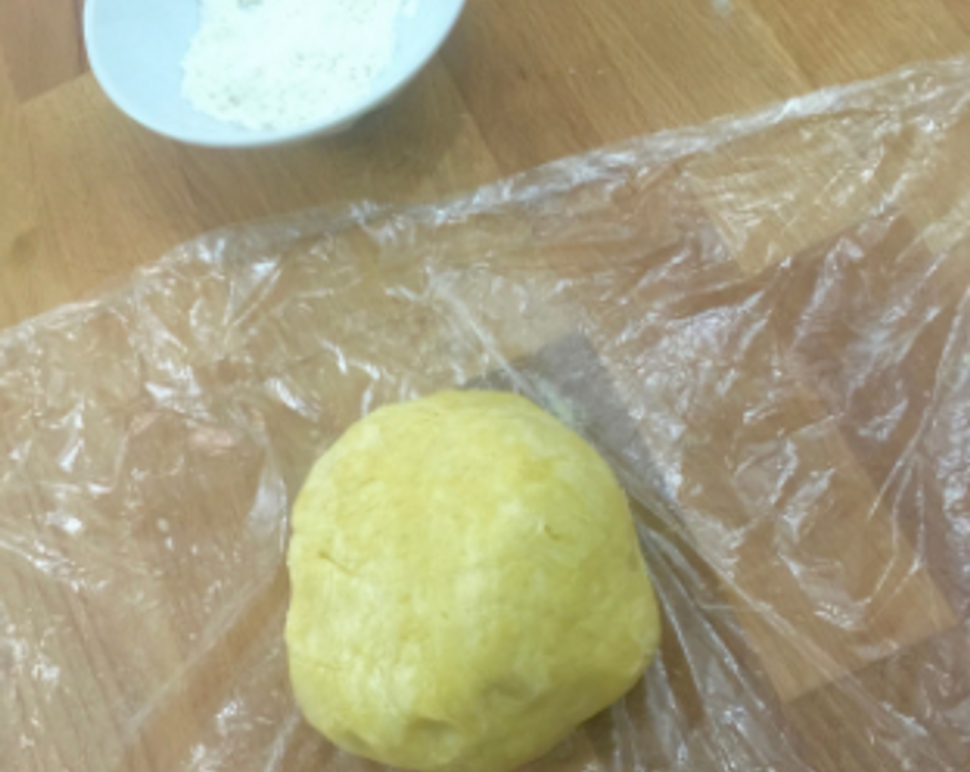 step 8 Using the plastic wrap, gather the dough together into a ball. (The less you handle the dough the better).