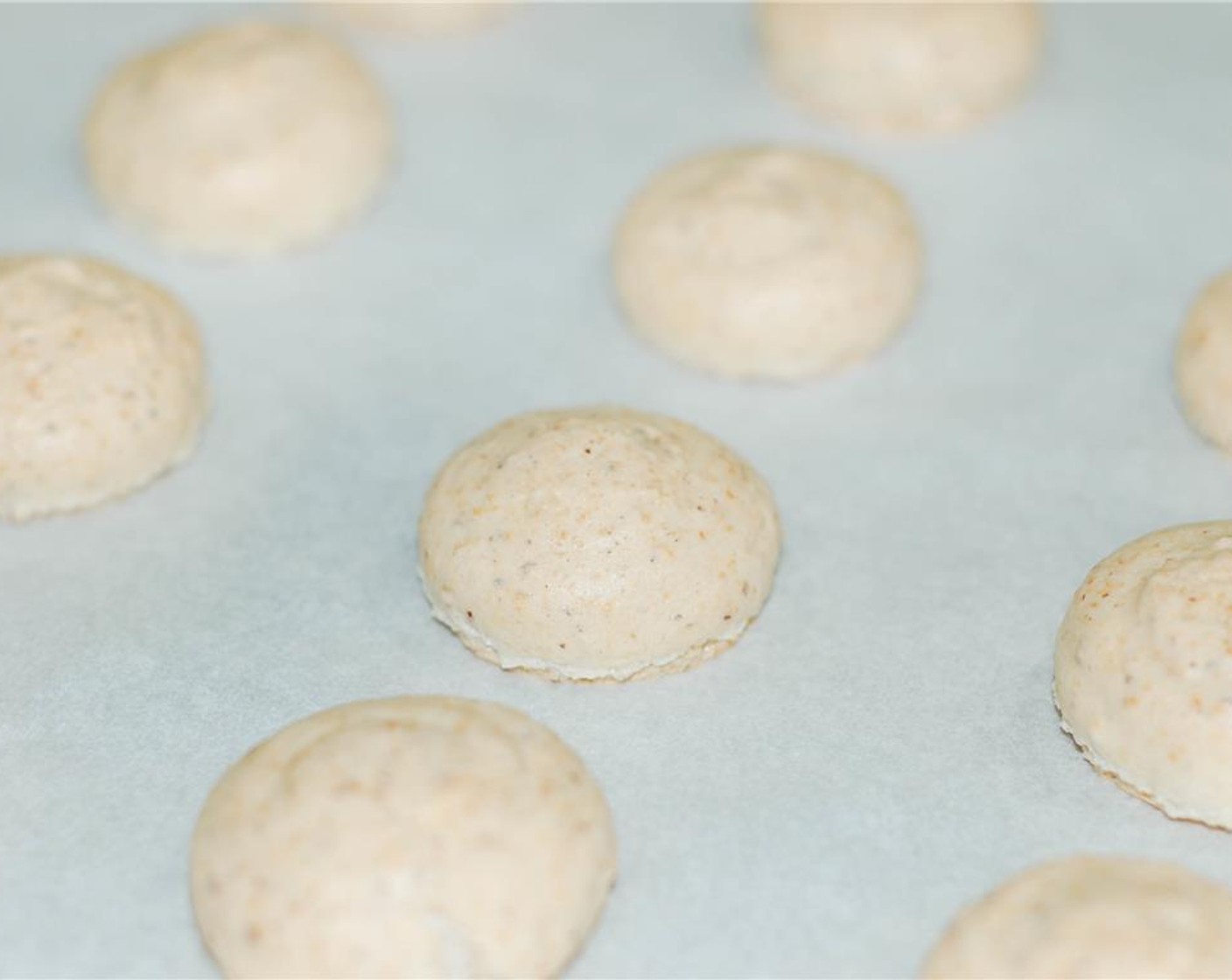step 12 Remove from oven and let cool for 2-3 minutes. Then carefully remove the macarons from parchment paper and place on a wire rack to cool completely.