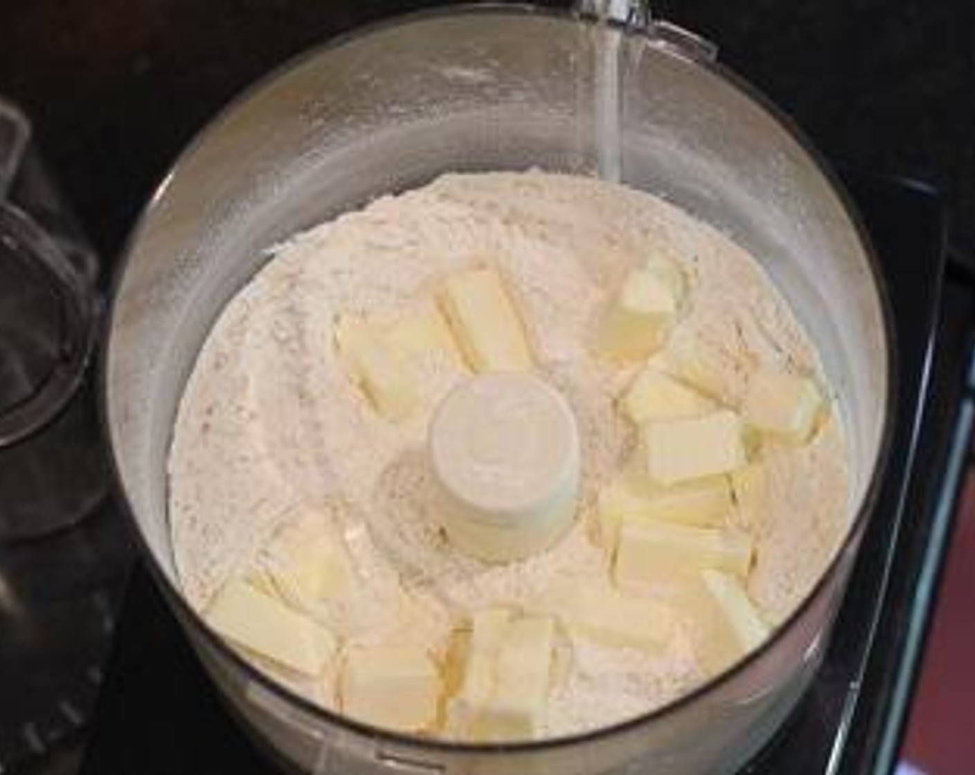 step 2 Whisk together All-Purpose Flour (2 cups), Baking Powder (2 tsp), Baking Soda (1/4 tsp), and Coarse Salt (1 tsp) in processor. Place Unsalted Butter (1/2 cup) in processor and pulse until mixture resembles coarse meal.