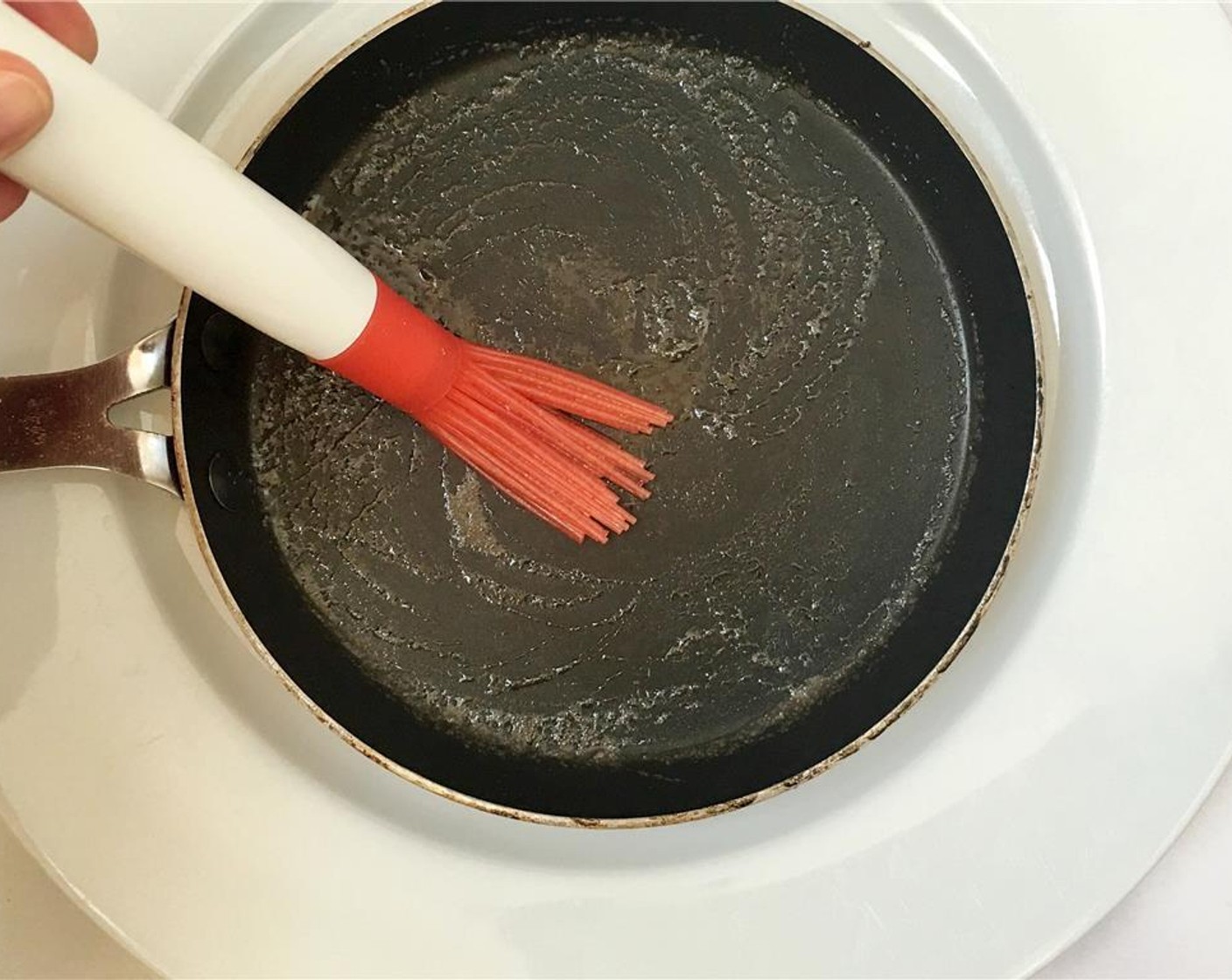 step 6 Let the batter rest for 45 minutes at room temperature before baking the crepes. Brush a non-stick frying pan with a little drop of Vegetable Oil (4 Tbsp) (or melted butter).