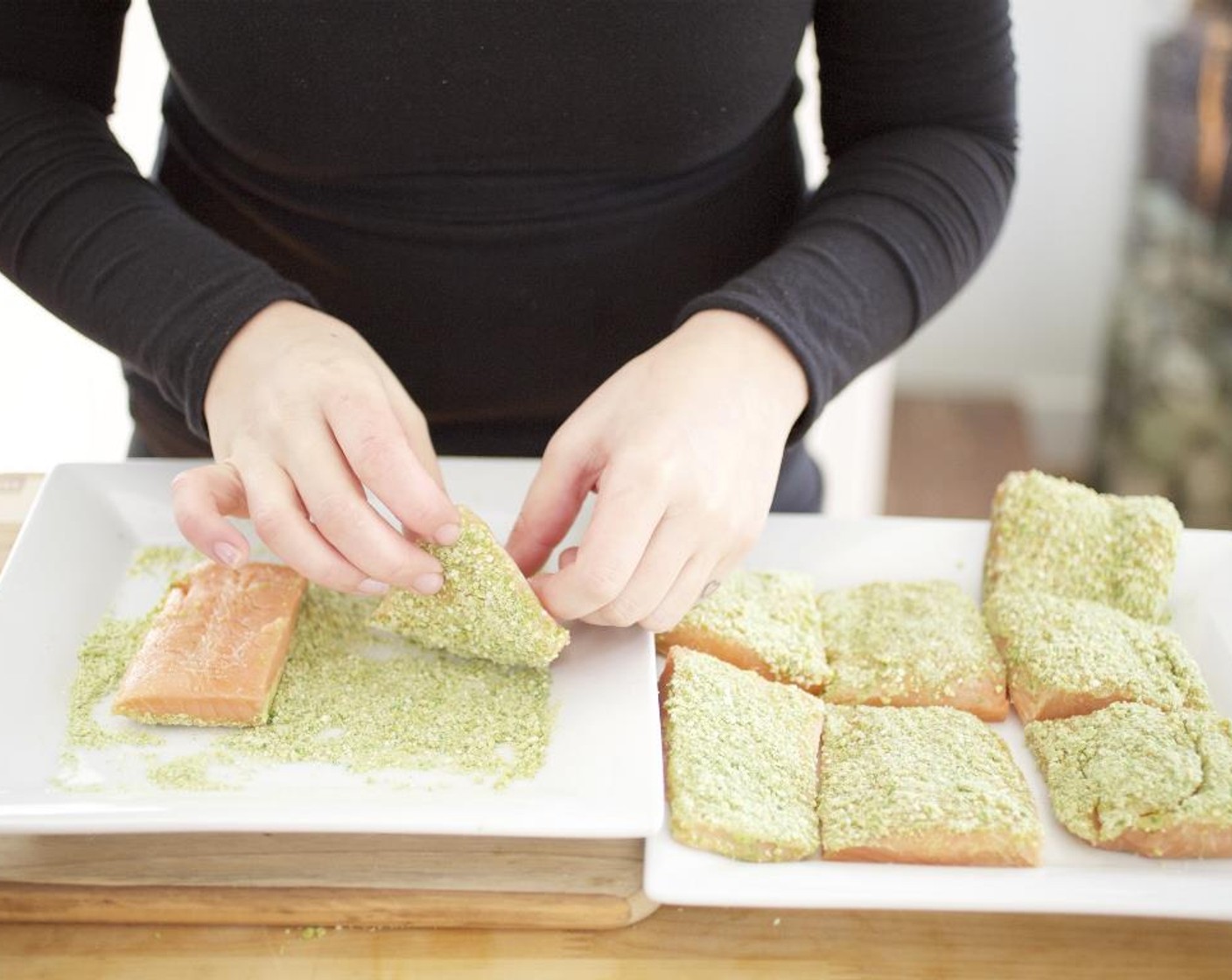 step 14 Spread the wasabi paste on all sides of the salmon fillets until well coated. Press only one side of the salmon into the crushed wasabi peas.