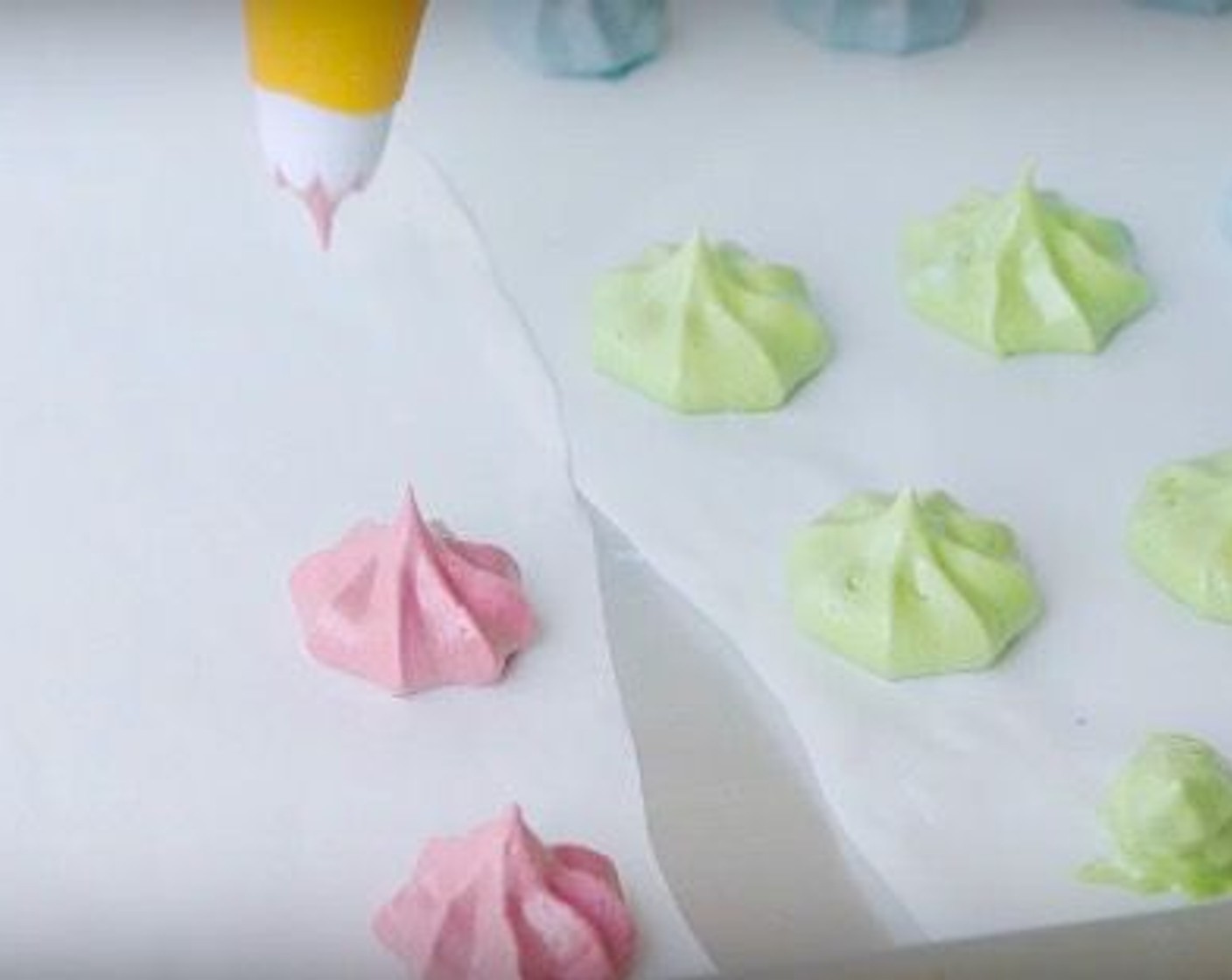 step 13 Pipe meringue kisses onto a baking sheet lined with parchment paper with a star-fitted tip. They should be slightly smaller in circumference than your macaron shells.