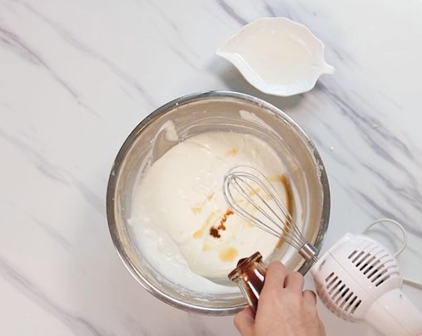 step 3 Drizzle in Heavy Cream (3/4 cup) into the cream cheese mixture and whip until the mixture is thickened. Flavor it with some Rum (2 Tbsp) and Vanilla Extract (1 tsp). Continue beating until the mixture thickens back, leaving a ripple effect when it’s being mixed.