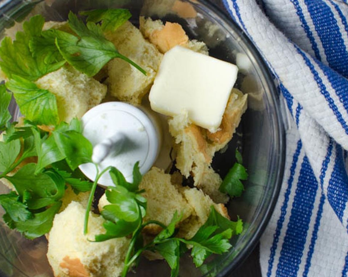 step 11 Tear the Bread (1 slice) into chunks and add them to the mini prep food processor. Add the Butter (1 Tbsp) and Italian Flat-Leaf Parsley (4 Tbsp) and pulse until bread crumbs are formed.