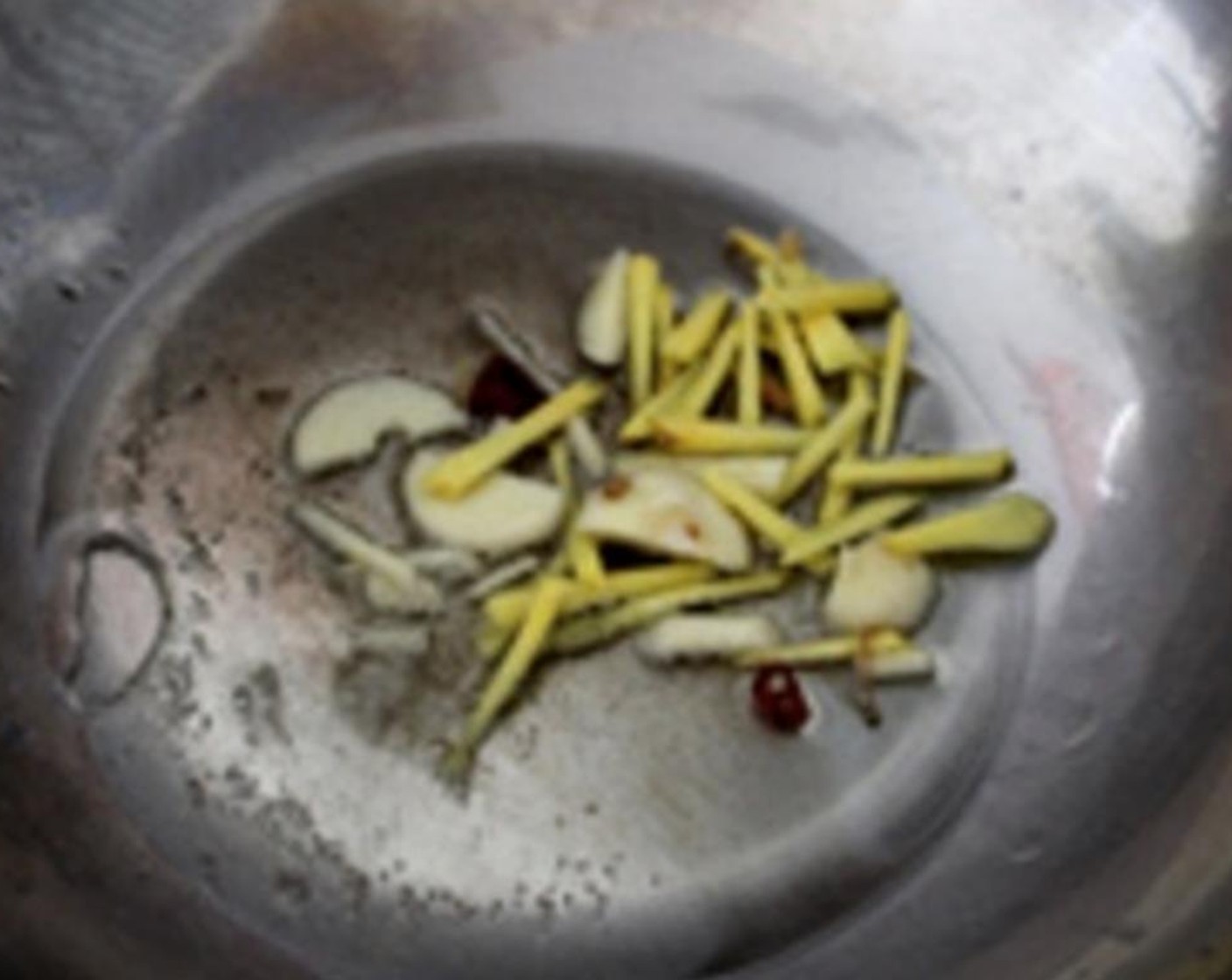 step 3 Add Vegetable Oil (2 Tbsp) to a wok. add Garlic (to taste), Fresh Ginger (to taste) for 2 minutes.