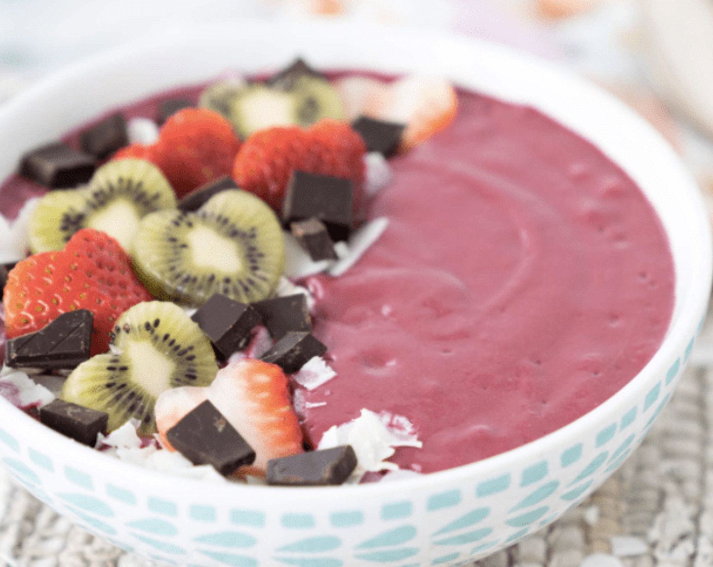 step 3 Add any toppings your heart desires! I added Kiwifruit (to taste), Fresh Strawberry (1 cup), Unsweetened Coconut Flakes (to taste) and chunks of Dark Chocolate (to taste). Serve and enjoy!