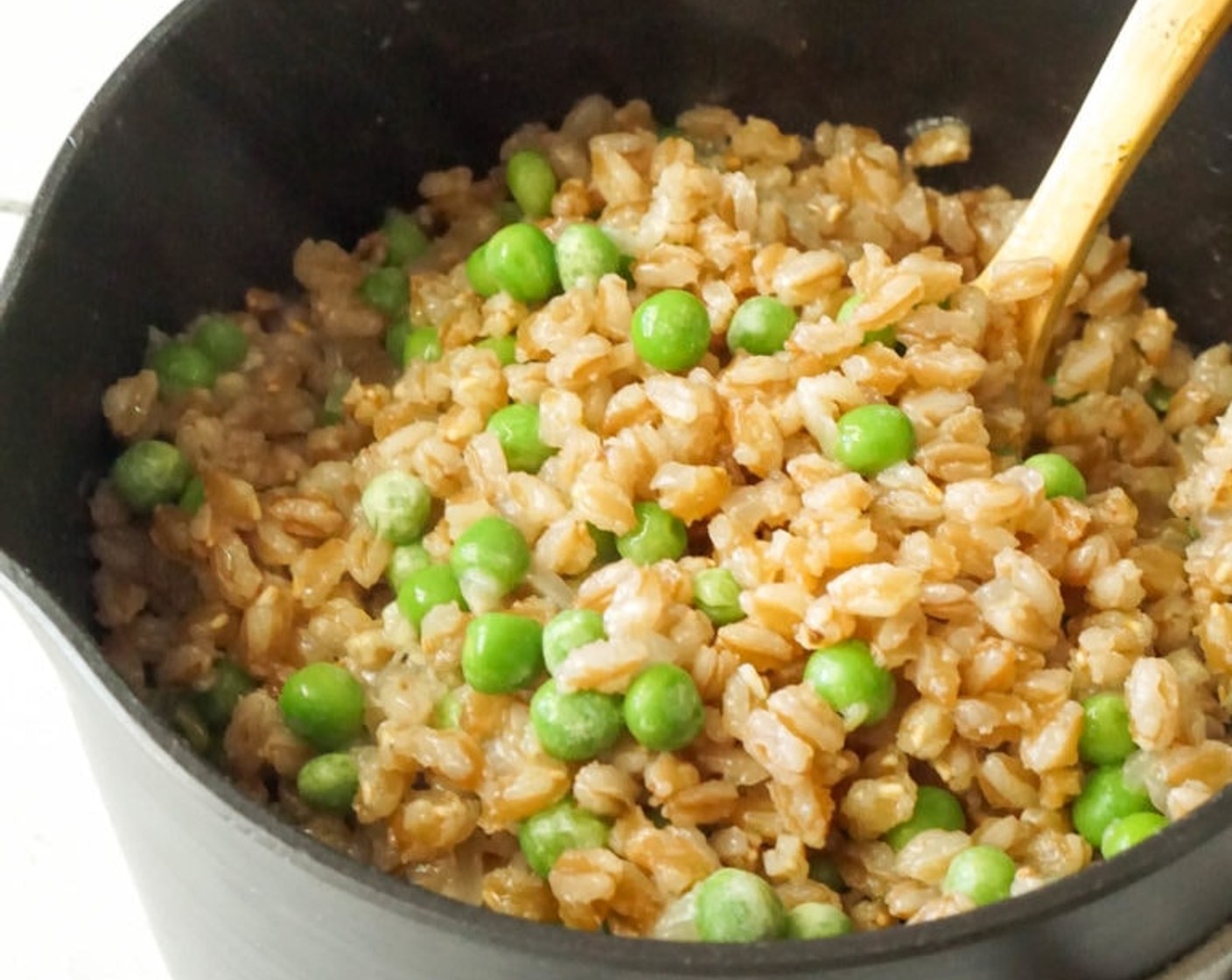 step 9 Once the farro is cooked, remove from the heat and stir in the Frozen Green Peas (1/2 cup). Season with Garlic Salt (to taste) and Ground Black Pepper (to taste), tasting and adjusting as needed.