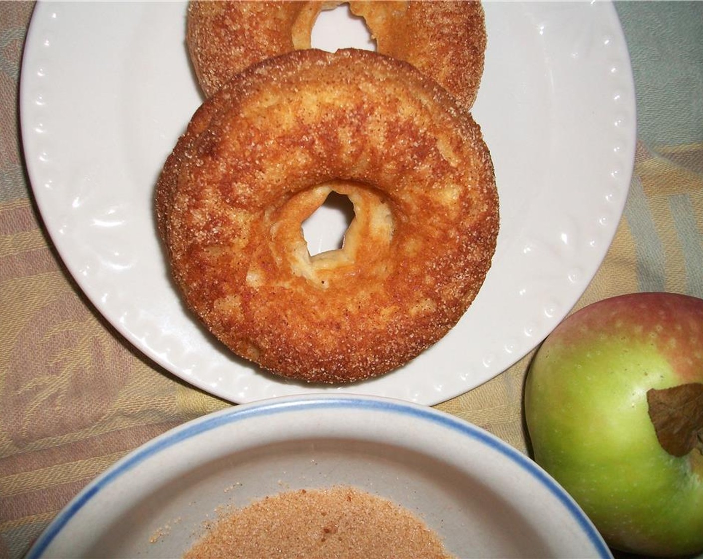 step 7 While they are still warm, dip the donuts into mixture of Ground Cinnamon (to taste) and Granulated Sugar (to taste).