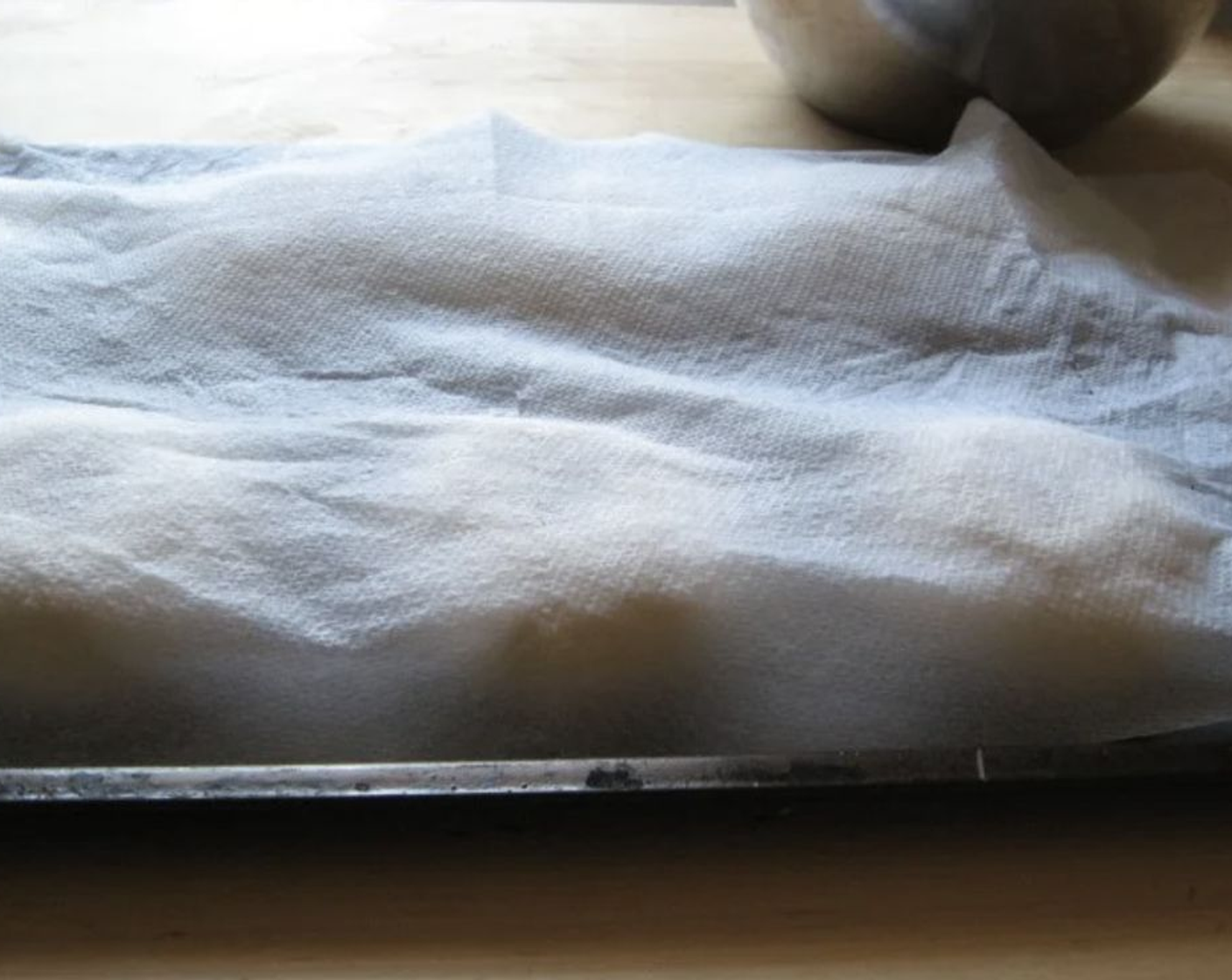 step 8 After shaping the dough rounds and placing them on the cookie sheet, cover with a damp kitchen towel and allow to rest for 10 minutes.