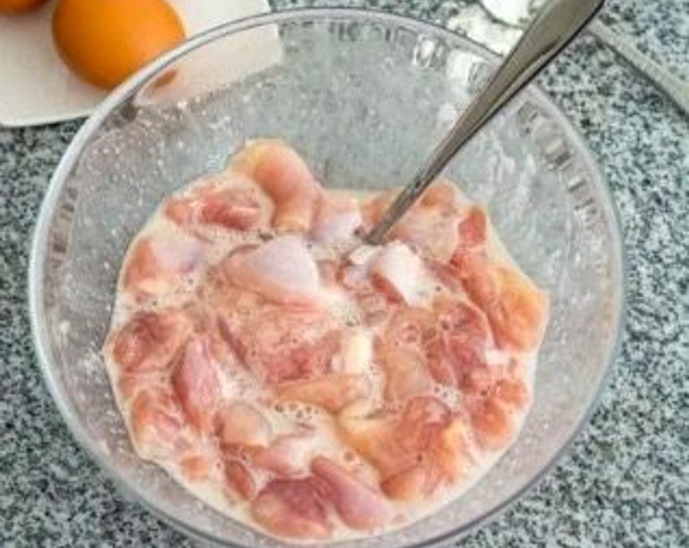 step 2 Marinate the Chicken Thigh (1 lb) in Corn Starch (1 Tbsp), Salt (1 tsp), Ground Black Pepper (1 dash), and the white of an Egg (1) for 15 minutes at room temperature.