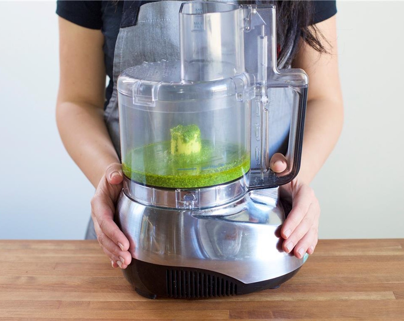 step 3 To create the pesto, pour Olive Oil (1/2 cup), Fresh Baby Spinach (3 3/4 cups), basil, Pine Nuts (2 Tbsp), Garlic (4 cloves), and lemon juice into the bowl of a food processor.