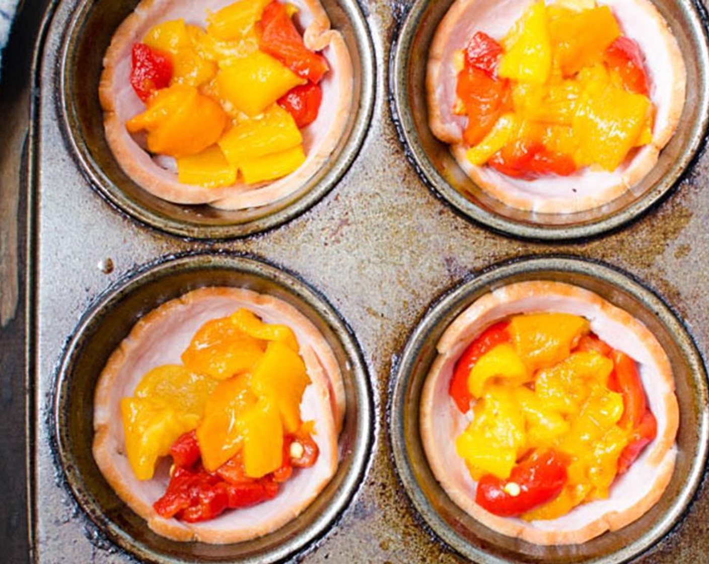 step 5 Dice the Bell Pepper (1/2 cup) into 1/2-inch pieces and divide evenly among the muffin tins.