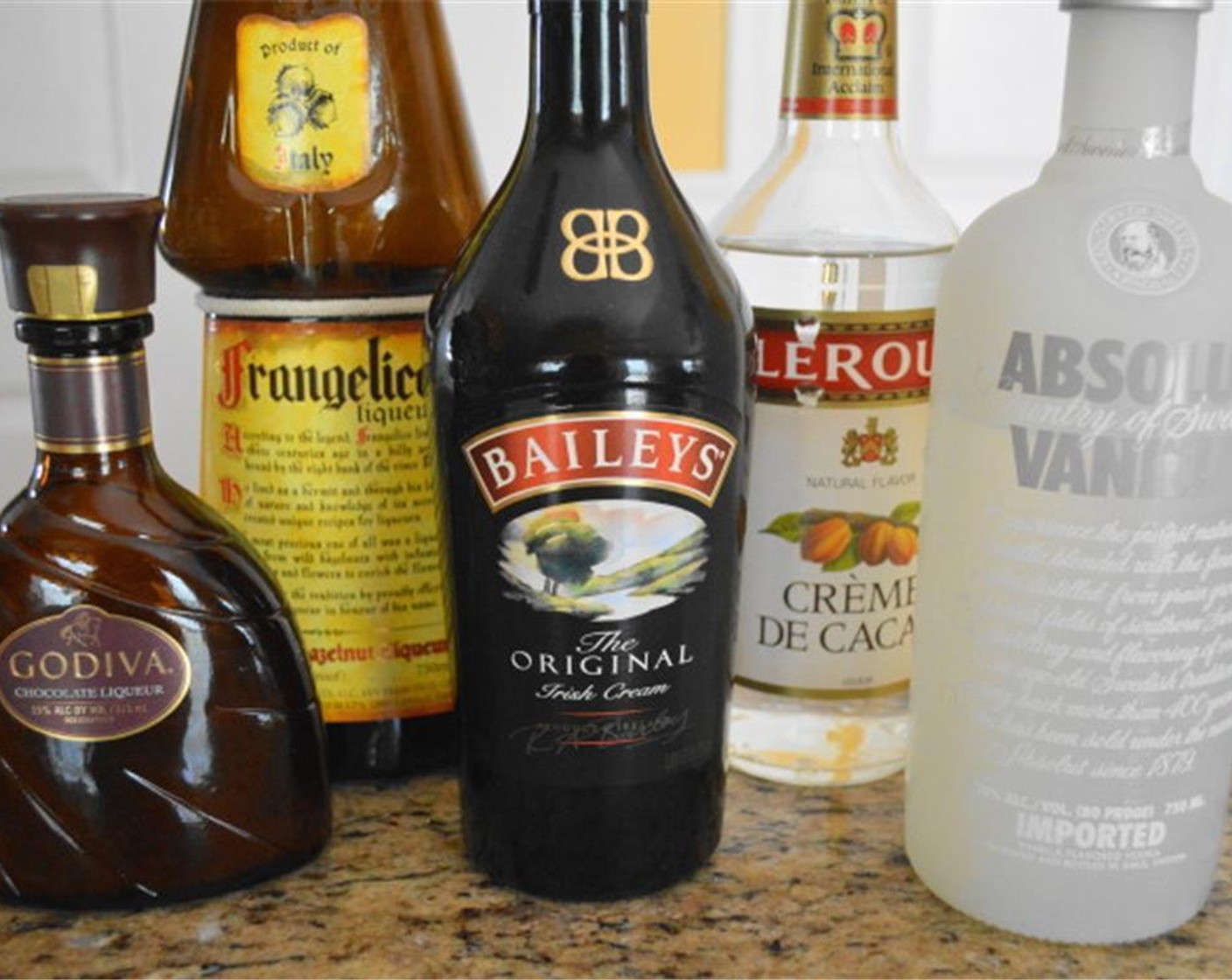 step 3 Pour ice into a drink shaker. Add Absolut® Vanilla Vodka (1/3 cup), Godiva® Chocolate Liqueur (1/4 cup), Chocolate Liqueur (2 Tbsp), Frangelico (2 Tbsp) and Bailey's® Irish Cream (2 Tbsp). Give it a good thorough shake to make sure it is well combined.