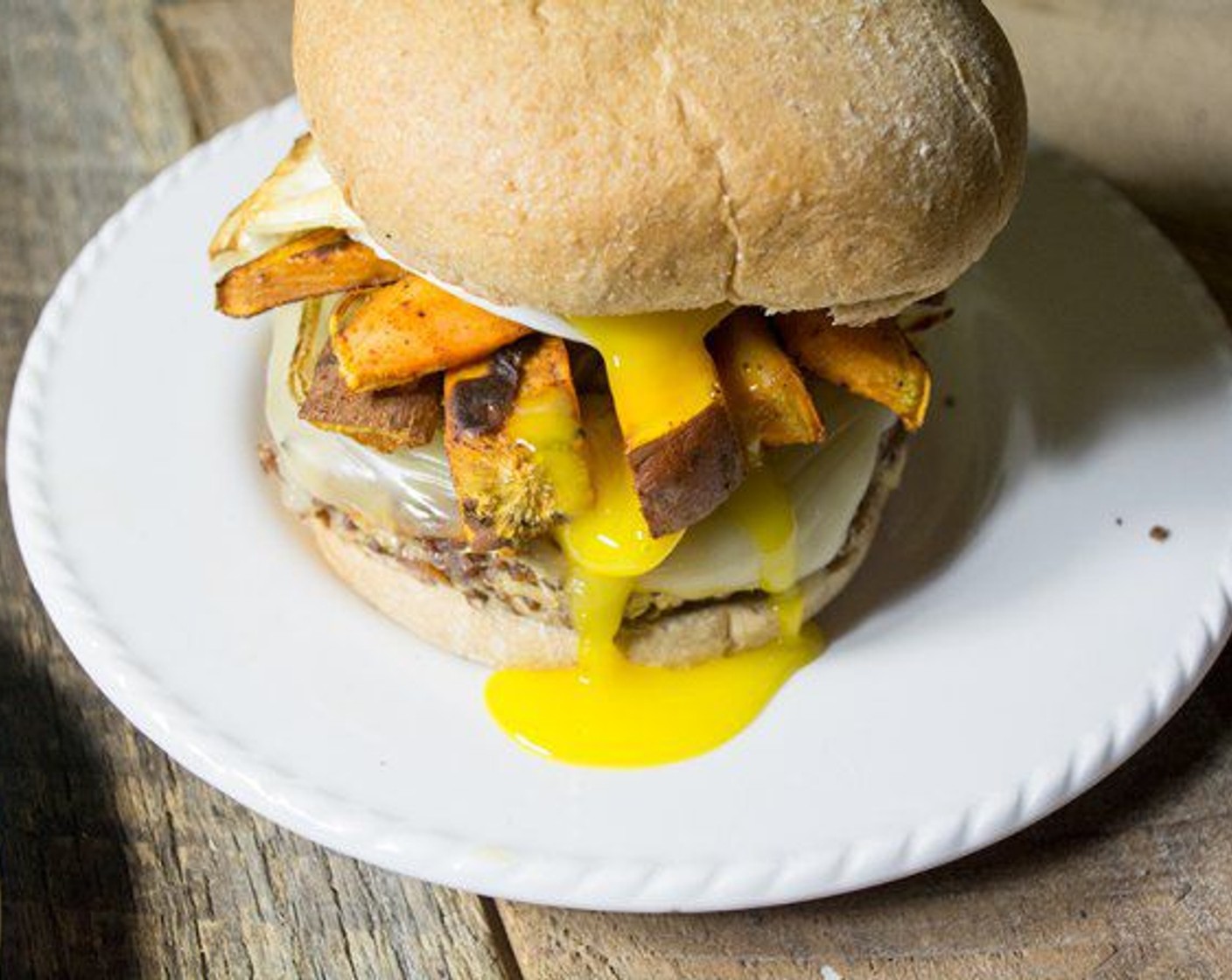 step 11 To assemble the burgers, place each burger on a Hamburger Buns (6) with equal amounts of caramelized onions and sweet potato fries. Add the egg and serve!