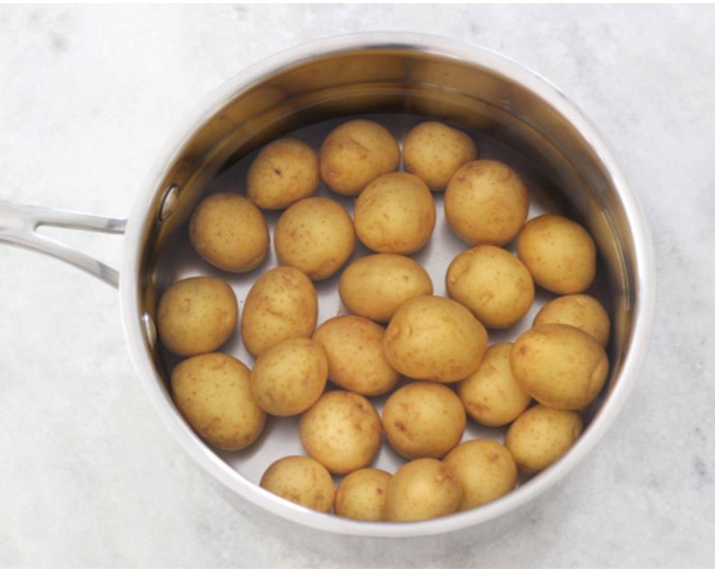 step 2 Meanwhile, place the Baby Potatoes (1.3 lb) into a medium pot and add just enough water to cover the potatoes.