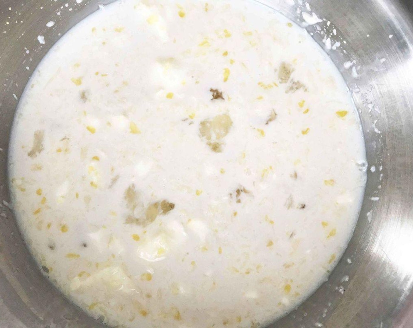 step 6 In another medium bowl, whisk together 2% Reduced Fat Milk (2 cups), Maple Syrup (1/3 cup), lemon juice and zest, Farmhouse Eggs® Large Brown Egg (1), melted butter, and Vanilla Extract (2 tsp).