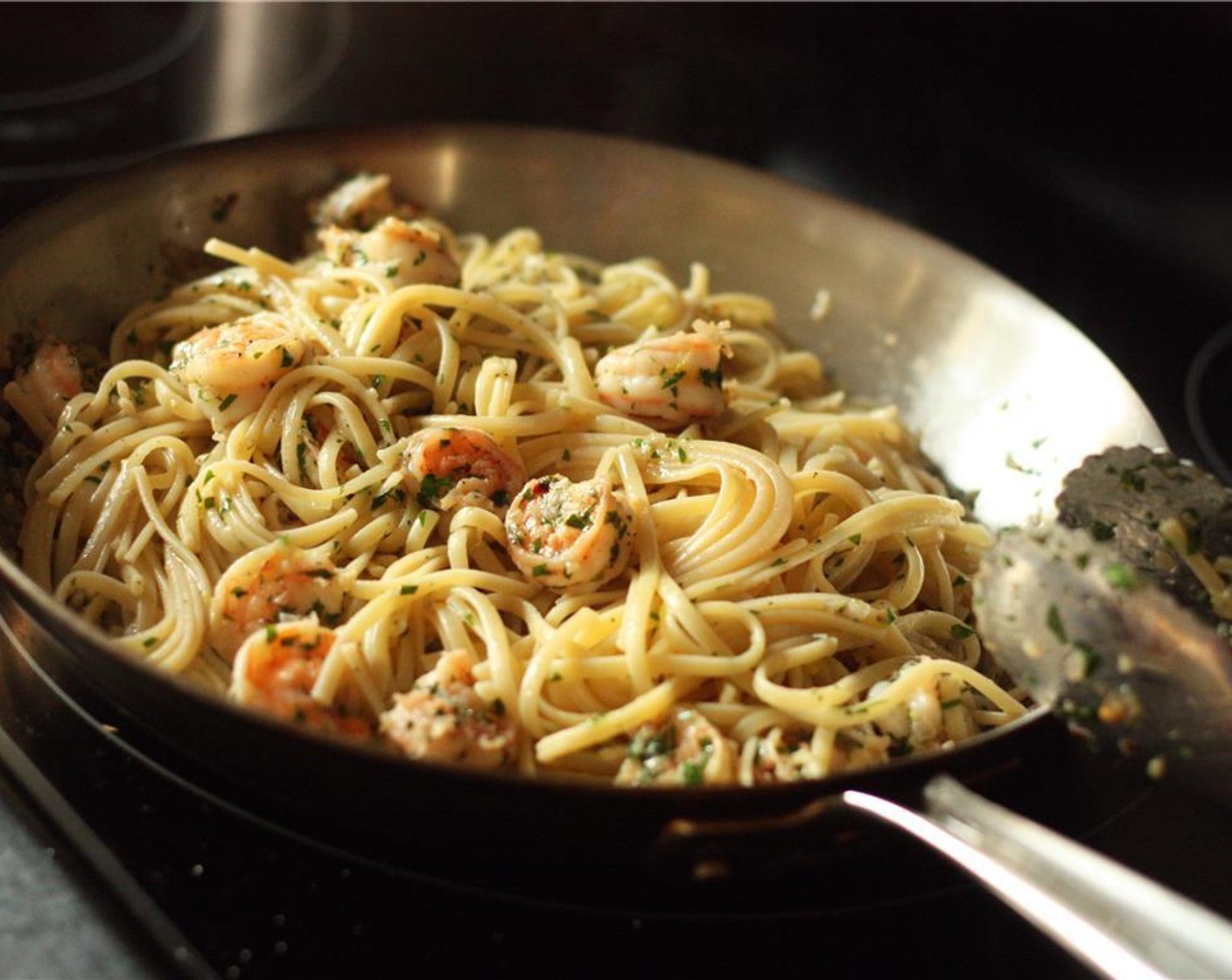 step 6 When al denté, drain the linguine in a colander and add it to the shrimp mixture. Toss to coat all pasta.