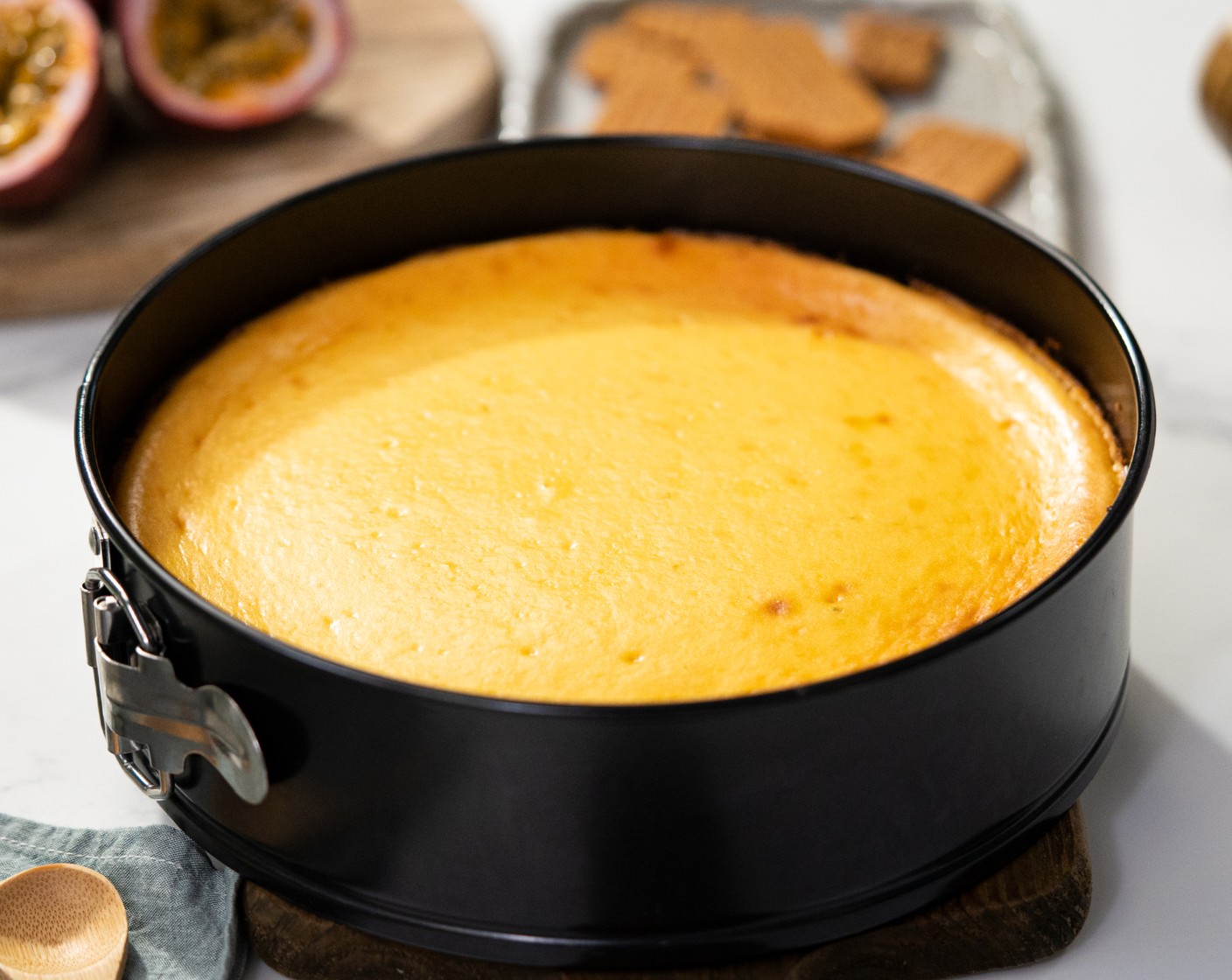 step 9 Bring the cheesecake out of the oven and leave it at room temperature for about 30 minutes. Meanwhile, in a mixing bowl, mix together the Sour Cream (3/4 cup), Passion Fruit Juice (2 Tbsp), and Granulated Sugar (1 Tbsp).