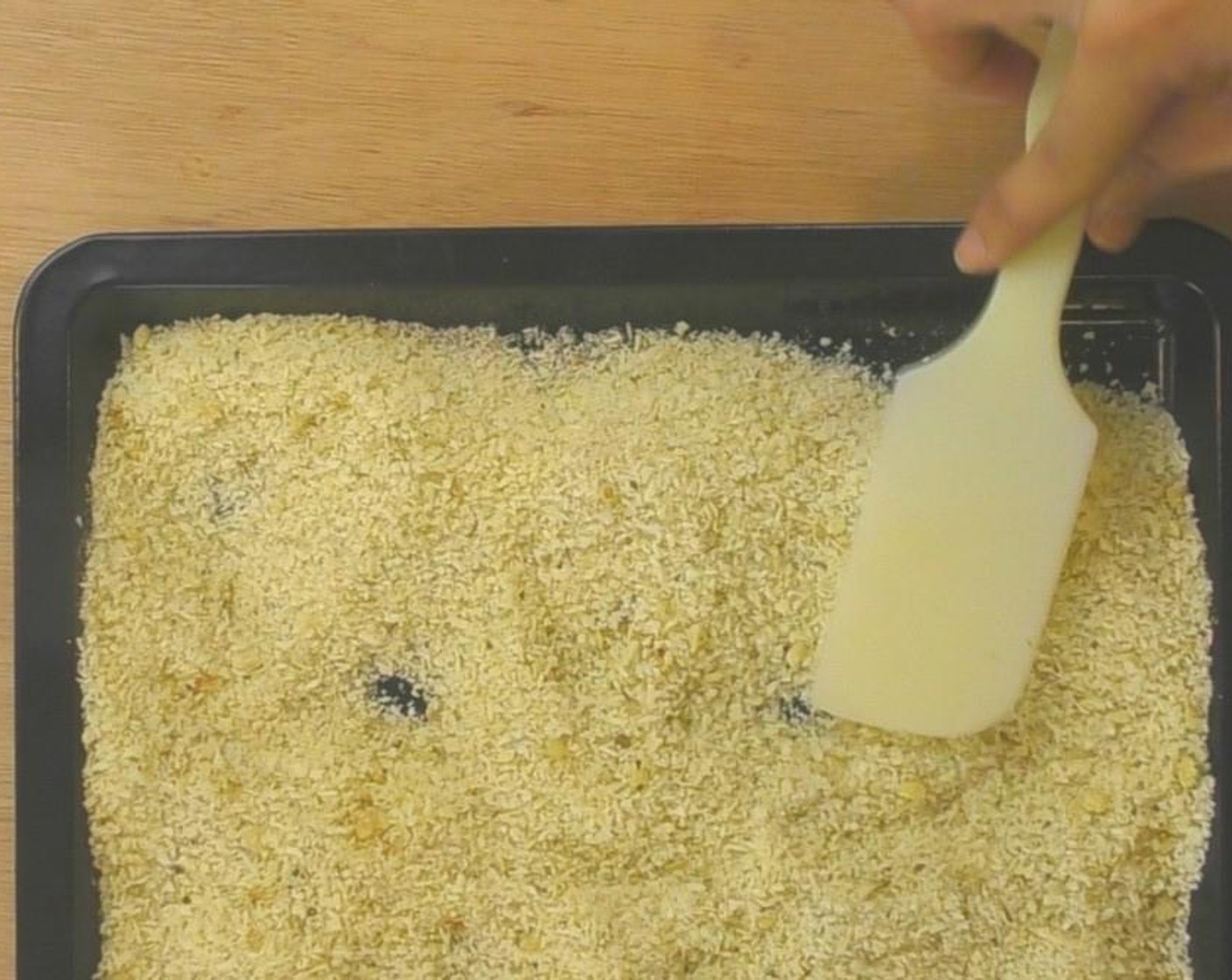 step 3 Then spread half the breadcrumb mixture onto a baking dish and set aside.