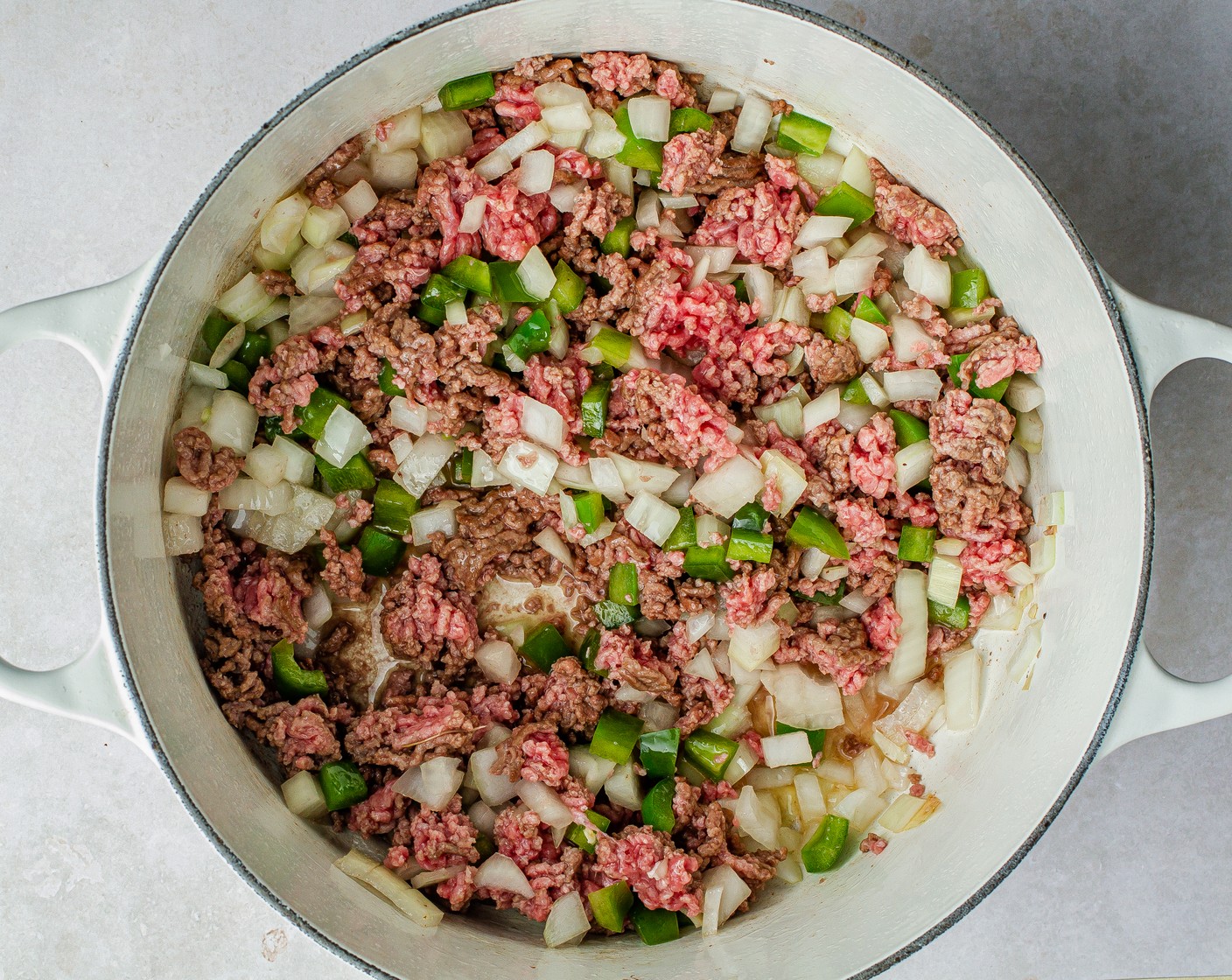 step 4 Heat a large pot over medium heat, add Canola Oil (2 Tbsp), 80/20 Lean Ground Beef (2 lb), onions, and bell peppers, and cook for 8 minutes until the meat is no longer pink.