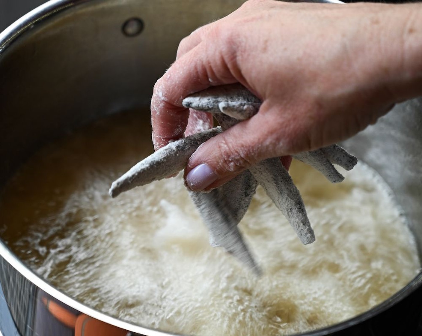 step 7 Deep-fry the whitebait in batches, draining the fried fish on kitchen towel.