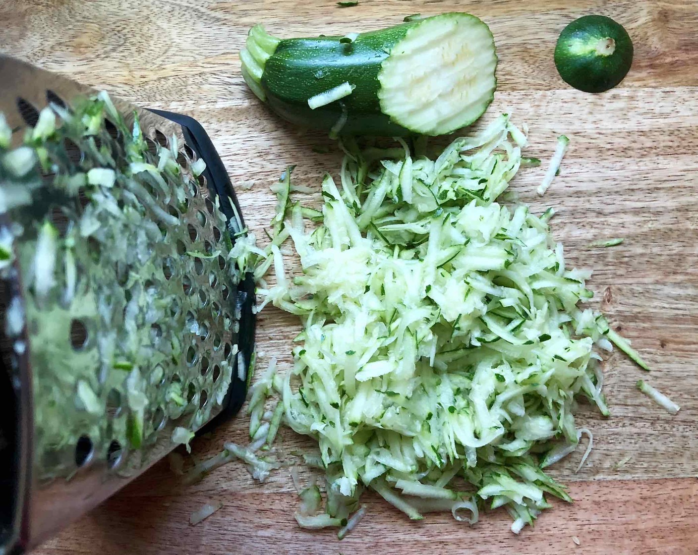 step 7 Shred the Zucchini (1 1/2 cups) a grater on the large side. Do not squeeze the moisture out of the shredded zucchini.