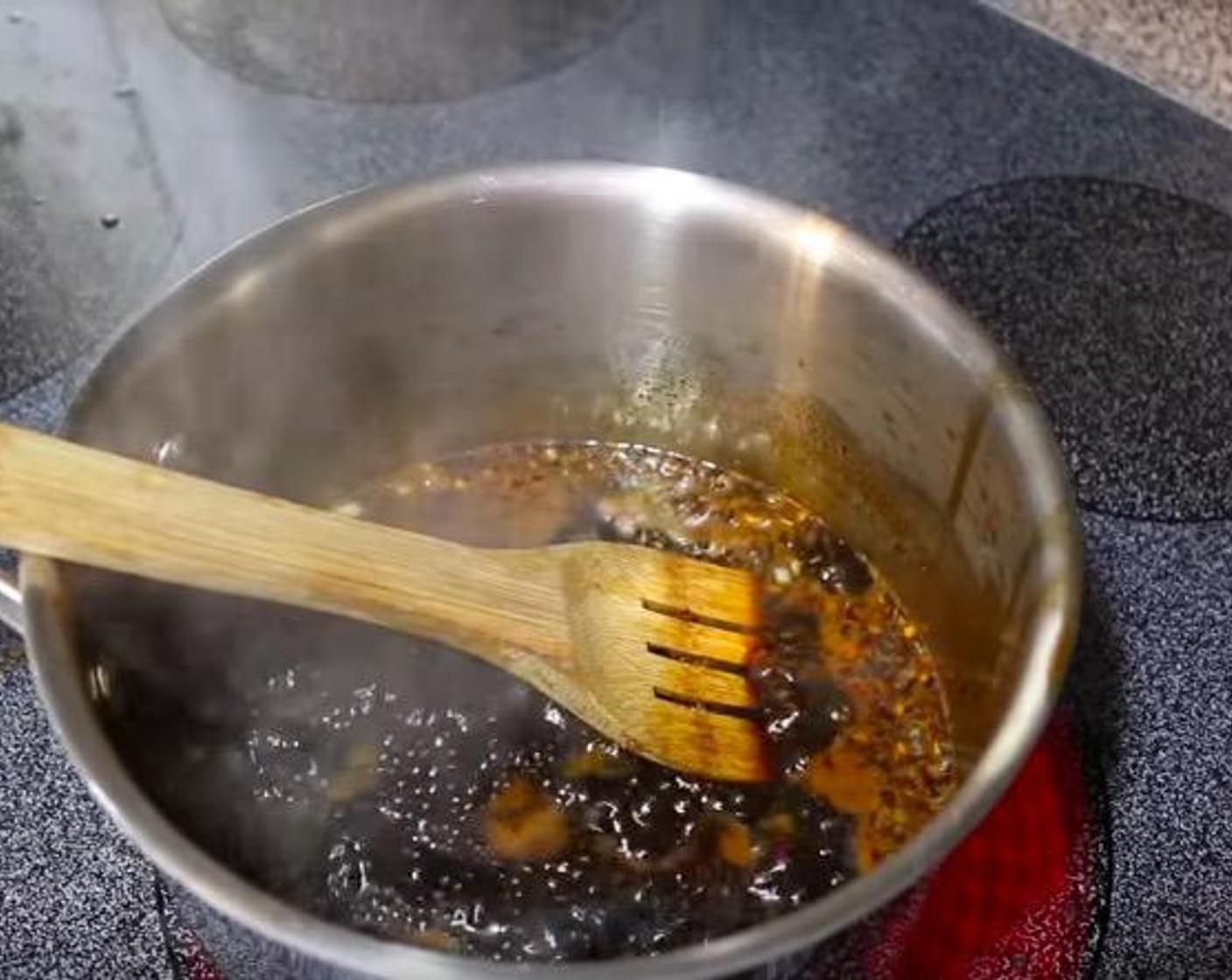 step 3 Stir in the Sweet Chili Sauce (1 Tbsp), Chili Garlic Paste (1 tsp), and Crushed Red Pepper Flakes (1 Tbsp). Continue cooking until mixture reaches a slight boil.