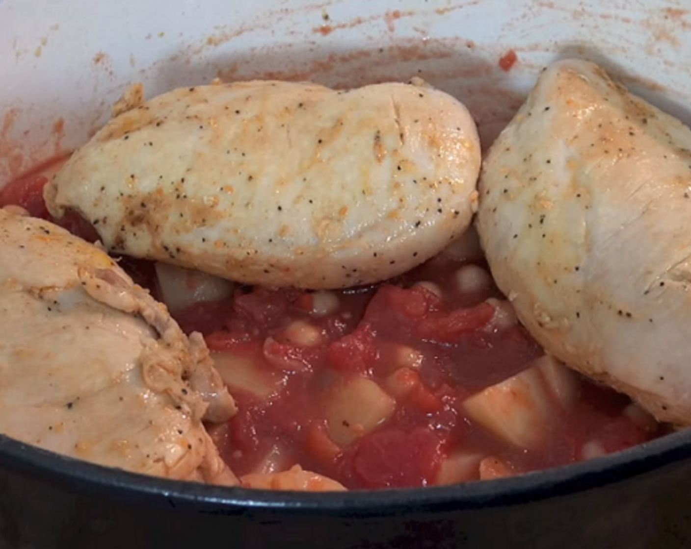 step 4 Add Garlic (1 clove), Canned Chickpeas (2 cups), Canned Diced Tomatoes (3 1/2 cups), Salt (to taste), and Ground Black Pepper (to taste) and stir together. Add the chicken back on top and cook at 220 degrees C (425 degrees F) for 15-20 minutes or until the chicken is cooked all the way through.