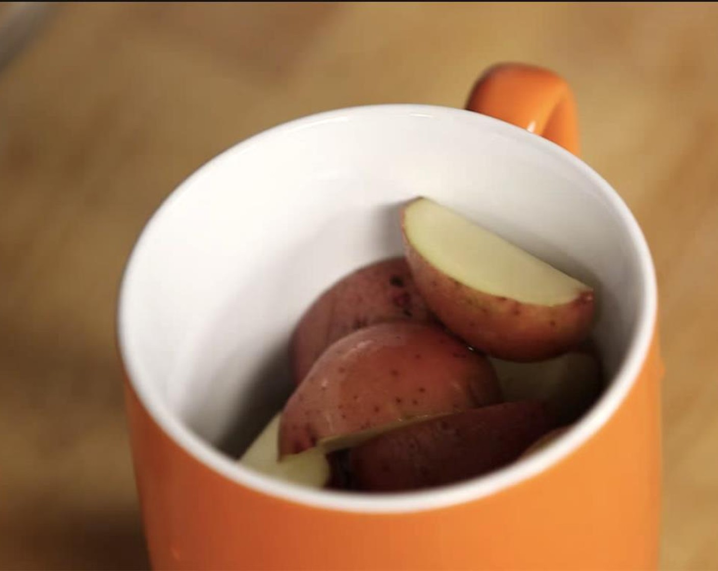 step 2 Wash and quarter the Red Potatoes (4). Into a mug, add the potatoes and Water (1/4 cup).