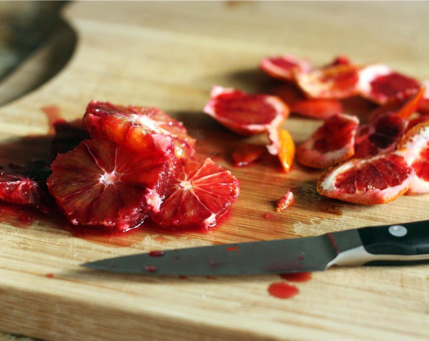 step 2 Slice away the peel of the remaining half and the remaining whole orange, then carefully slice into disks. Set the oranges aside.